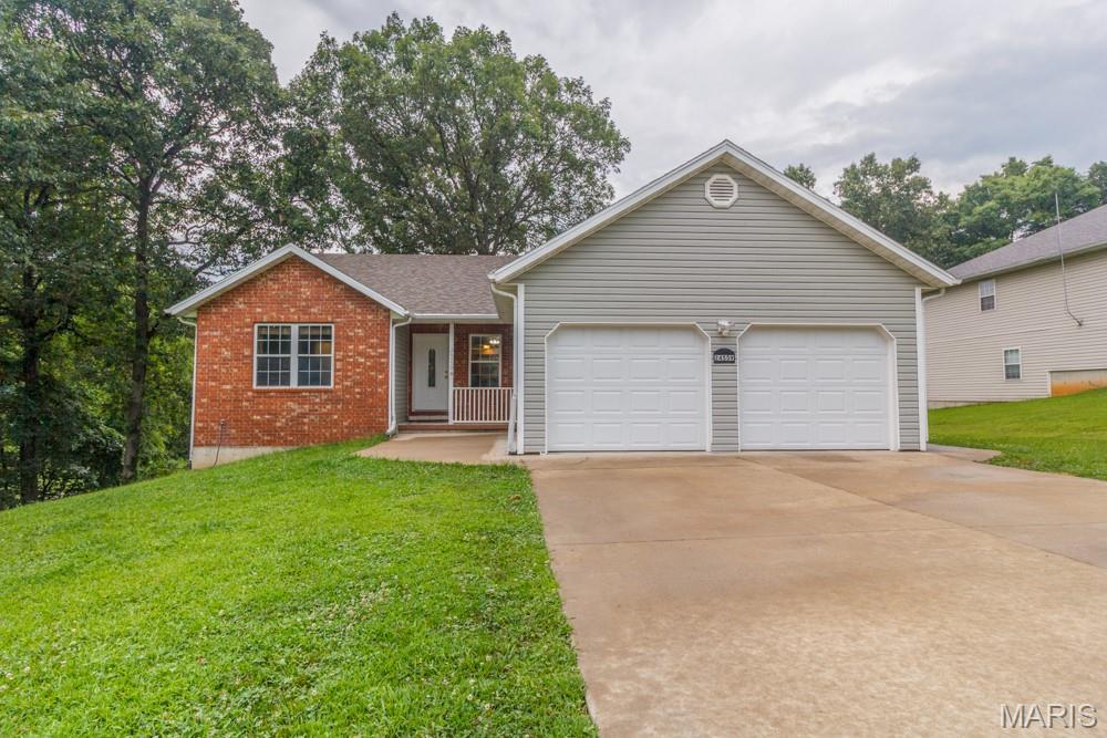 Welcome home to this beautifully maintained 4-bedroom, 3-bath home with a full basement, situated on a 0.35-acre lot in St. Robert and conveniently located just 10 minutes from the front gate of Fort Leonard Wood. Offering a spacious open floor plan and numerous recent updates, this home is truly move-in ready.

Recent improvements include luxury vinyl plank flooring throughout the living room, kitchen, and dining area; fresh paint throughout the majority of the home;  brand-new carpeting in the main-floor bedrooms and basement stairs; new garage doors; and a full concrete driveway. Additional major updates include a roof that's approximately 5 years old and a new HVAC system installed in 2022, providing peace of mind for years to come.

The spacious kitchen offers an abundance of oak cabinetry and generous countertop space and flows seamlessly into the formal dining room, where you'll enjoy beautiful views of the backyard—perfect for everyday living or entertaining family and friends.

The primary suite is generously sized and features a walk-in closet along with a private bathroom complete with a stand-up shower. Two additional main-level bedrooms offer comfortable layouts and ample closet space.

Downstairs, the basement is mostly finished and provides exceptional additional living space with a large family/recreation room featuring ceramic tile flooring and a propane fireplace (currently not connected). You'll also find a spacious fourth bedroom, a full bathroom, a dedicated storm shelter area, a versatile bonus room that's perfect for a media room, home office, or hobby space,  and a large storage room.

Step outside to enjoy the covered front porch or relax on the rear deck overlooking the spacious backyard with mature shade trees—ideal for outdoor entertaining, children, pets, or simply unwinding after a long day.

Additional features include an attached two-car garage, a full concrete driveway, and a location that places you just minutes from Fort Leonard Wood, shopping, dining, and everyday conveniences.

This well-cared-for home offers the perfect combination of space, comfort, and quality updates in a highly convenient location. Don't miss your opportunity to make this exceptional property your next home!