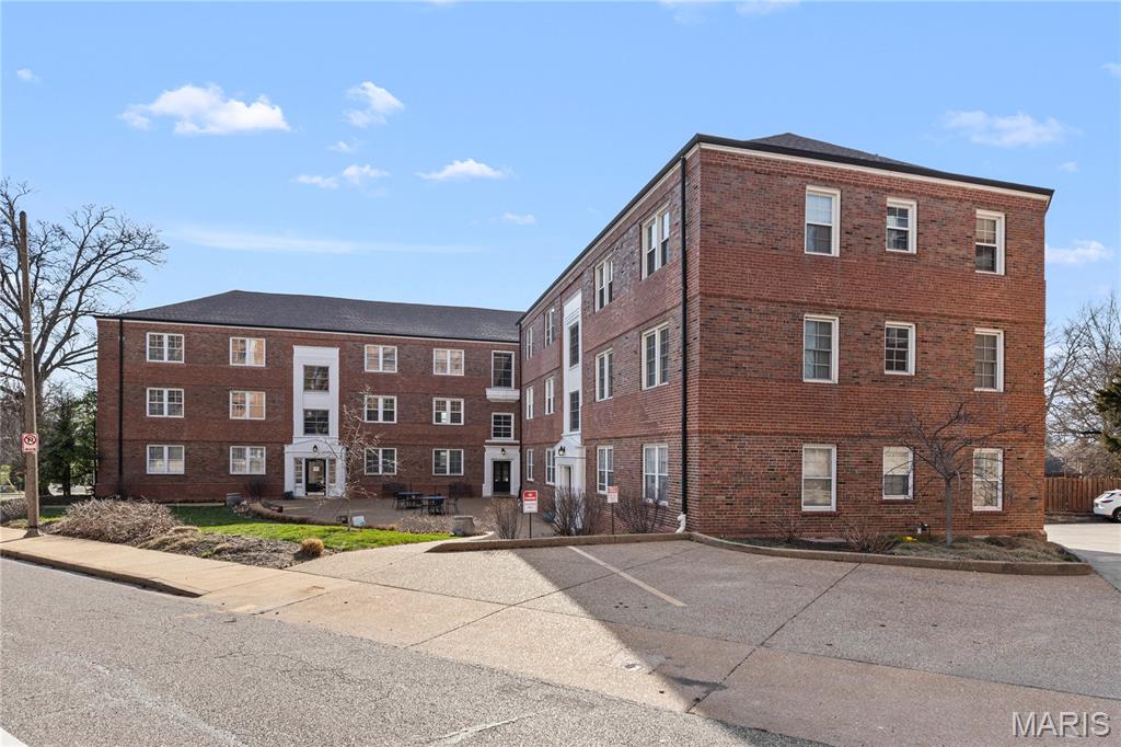 Charming Main Floor Condo at Davis Place In the heart of Clayton. This one bedroom unit is loaded with classic style. The large living room features newer flooring and lots of natural light, and is open to the kitchen with Modern, Updated Cabinetry, solid surface countertops, stainless steel appliances, breakfast bar, and attached dining area. Down the hall is the large bedroom and full bathroom. Multiple closets throughout. Secure entry. Beautiful community patio/courtyard area for entertaining and visiting with neighbors. Community Laundry area in basement with the ability to add an in-unit laundry. One assigned parking space and storage unit in lower-level garage. Walk to shopping, dining, nightlife, and ALL that Downtown Clayton has to offer.