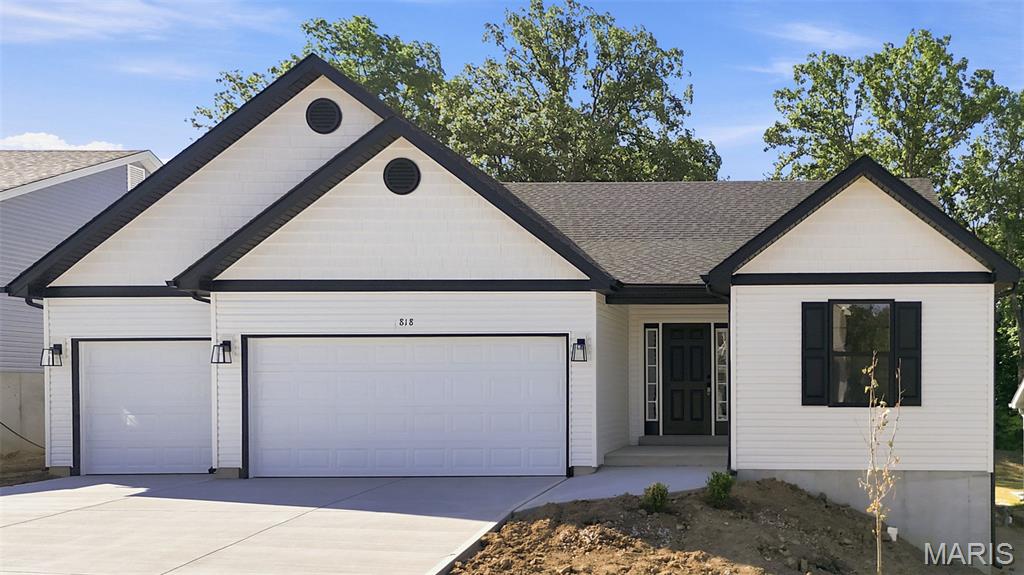 Discover the great curb appeal and allure of contemporary living at 818 Dogwood Way in Hillsboro at this new construction home built in 2026.   Need extra space for the vehicles and toys?  You are surely to enjoy the 3-car garage that offers just that!  The heart of this home is undoubtedly its Kitchen, a space crafted for both culinary exploration and casual gatherings. It features upgraded 42" tall Maple cabinets, wood ends, hidden hinges, handles etc. with a Center island, complete with an 8" deep sink (with the popular goose neck faucet/handle), creating an inviting hub for meal preparation and conversation.  This home also features the split bedroom floor plan with having the Primary Bedroom Suite on one side of the home and Bedroom 2 & 3 on the other side.  The Primary Bath offers the convenience of a double bowl vanity and a spacious walk-in shower, with a seat and glass shower doors, providing a spa-like experience within your own home. Beyond the main living areas, a versatile Great Room provides ample space for relaxation or entertaining.  Step outside to enjoy the 13' x 12' covered patio, with a ceiling fan, perfect for enjoying the outdoors in any weather. This property backs to trees and offers the perfect amount of privacy!  Fully sodded yard to be installed at disturbed areas only, weather permitting.  At this home you will find a harmonious blend of comfort and functionality, ready to become your new home.  2-10 Home Warranty included