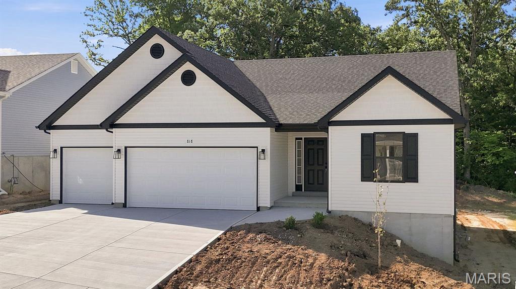 Discover the great curb appeal and allure of contemporary living at 818 Dogwood Way in Hillsboro at this new construction home built in 2026.   Need extra space for the vehicles and toys?  You are surely to enjoy the 3-car garage that offers just that!  The heart of this home is undoubtedly its Kitchen, a space crafted for both culinary exploration and casual gatherings. It features upgraded 42" tall Maple cabinets, wood ends, hidden hinges, handles etc. with a Center island, complete with an 8" deep sink (with the popular goose neck faucet/handle), creating an inviting hub for meal preparation and conversation.  This home also features the split bedroom floor plan with having the Primary Bedroom Suite on one side of the home and Bedroom 2 & 3 on the other side.  The Primary Bath offers the convenience of a double bowl vanity and a spacious walk-in shower, with a seat and glass shower doors, providing a spa-like experience within your own home. Beyond the main living areas, a versatile Great Room provides ample space for relaxation or entertaining.  Step outside to enjoy the 13' x 12' covered patio, with a ceiling fan, perfect for enjoying the outdoors in any weather. This property backs to trees and offers the perfect amount of privacy!  Fully sodded yard to be installed at disturbed areas only, weather permitting.  At this home you will find a harmonious blend of comfort and functionality, ready to become your new home.  2-10 Home Warranty included