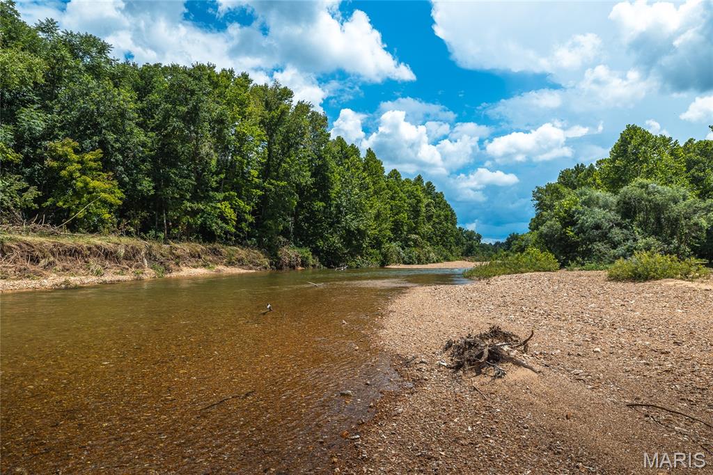 **520 ft HUZZAH VALLEY CREEK** If you love the creek and rural lifestyle. You need to be here, there is no better living than this! The home was built in 1892 and has been inpecibly maintained with stunning additions. It is ready for fulltime living, or weekends and is set up for vistors. You have 3 bedrooms- sleeping 8, and 4 bathrooms. The two story screened porches are amazing with a view of your valley. There is awesome additional building with celler, an office, garage/workshop space and large loft. The land is 81+/- acres, has a spring, beautiful pastures and 55 acres of woods to explore. The Huzzah Creek beach is fabulous, ready for swimming and floating. Only hour and half from St Louis, and 18 miles from Steelville Main Street. This is one that you don't want to miss. NO DRIVE BYS- Please make appointment.
