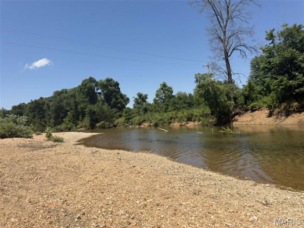 **520 ft HUZZAH VALLEY CREEK** If you love the creek and rural lifestyle. You need to be here, there is no better living than this! The home was built in 1892 and has been inpecibly maintained with stunning additions. It is ready for fulltime living, or weekends and is set up for vistors. You have 3 bedrooms- sleeping 8, and 4 bathrooms. The two story screened porches are amazing with a view of your valley. There is awesome additional building with celler, an office, garage/workshop space and large loft. The land is 81+/- acres, has a spring, beautiful pastures and 55 acres of woods to explore. The Huzzah Creek beach is fabulous, ready for swimming and floating. Only hour and half from St Louis, and 18 miles from Steelville Main Street. This is one that you don't want to miss. NO DRIVE BYS- Please make appointment. Professional Photos will be uploaded Monday and offers due by July 20.