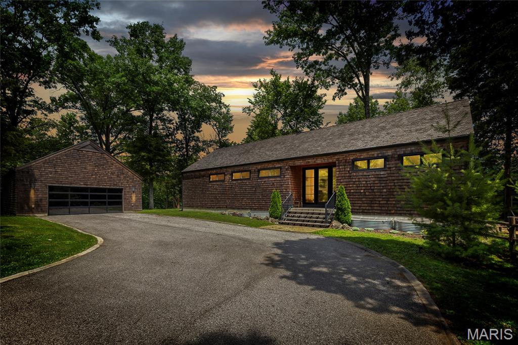 A rare opportunity to own a truly one-of-a-kind modern ranch estate where timeless architecture and refined contemporary design come together seamlessly. Designed and built in 2018 by its owner-architect, this exceptional residence is privately situated on 1.8 wooded acres in the heart of Wildwood, just minutes from top-rated Rockwood schools, Chesterfield conveniences, and the restaurants, shopping, and services along Highway 100.

Thoughtfully designed to maximize natural light and connection to the surrounding landscape, the home offers soaring ceilings, expansive walls of windows, and an open, airy floor plan throughout. The designer kitchen is both striking and functional, featuring quartz countertops, a dramatic marble feature wall, and premium Thermador appliances including a 36-inch gas range, built-in dual-column refrigerator, and Sharp drawer microwave.

The main level includes three bedrooms and two full baths, all elegantly integrated into approximately 1,700 square feet of refined living space. The luxurious primary suite offers a spa-inspired bath complete with a 9-foot walk-in shower, freestanding soaking tub, Toto bidet toilet, double vanity, and an impressive 12' x 7' walk-in closet.

The finished walk-out lower level adds over 1,600 additional square feet with generous 9-foot ceilings, a spacious family room, entertainer’s kitchenette, expansive nearly 400-square-foot office, full bath, laundry area, and abundant storage.

Constructed with both comfort and efficiency in mind, the home features geothermal HVAC, 2x6 exterior wall construction, and premium Pella wood-clad insulated windows and doors.

This is more than a home—it is an architectural statement offering privacy, craftsmanship, and modern luxury in one of Wildwood’s most desirable settings.