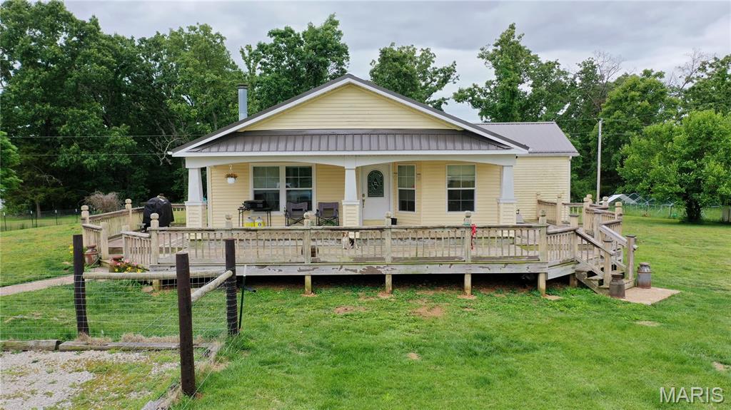 Escape to peaceful Ozark living with this beautifully maintained 3 (possibly 4) bedroom, 2 bath manufactured home on 19.70 unrestricted acres just 5 miles from town and only minutes from Cedar Grove and the Current River! Offering 1,560 sq. ft. of comfortable living space plus a full unfinished walkout basement, this property is packed with extras and ready for your mini farm or homestead dreams. The spacious living room features a stunning brick fireplace and abundant natural light, while the kitchen offers ample cabinet space, center island, appliances included, and gorgeous views of the property. Oversized primary suite includes a large walk-in closet, double vanity, separate shower and tub. A non-conforming 4th bedroom near the laundry area could easily serve as extra sleeping space, office, or hobby room. Home has a newer metal roof, well pump, and septic tank. Outside you’ll find mostly open fenced and cross fenced pasture with scattered trees, above-ground pool with deck, outdoor wood furnace, shed, and a stocked pond! Additional hookup for another home already in place. Great setup for the perfect mini farm. A must-see property with endless possibilities!