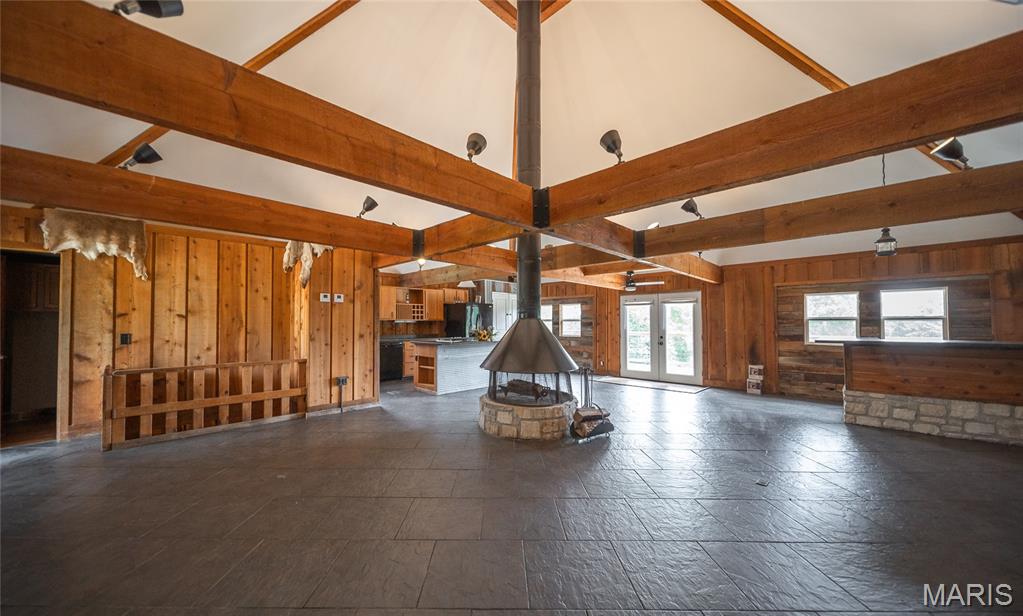 Rustic 4-5 bedroom 2.5 bathroom Retreat Near the Huzzah River on 8.3 Secluded Acres! If you’ve been searching for a property with character, privacy, and endless recreational opportunities, this is it. Located just 2.5 miles from the Scotia/Browns Access on the Huzzah River, this one-of-a-kind rustic retreat offers over 2,792 square feet of living space plus a mostly finished walkout basement. Inside, you’ll find soaring ceilings with exposed timber beams, a stunning central wood-burning fireplace, spacious gathering areas, and unique lodge-inspired finishes throughout. The home features 4 bedrooms, 2.5 bathrooms, plus an office that could easily serve as a 5th bedroom. The primary suite offers its own pellet stove, creating a cozy private retreat during the winter months. The kitchen is equipped with a gas cooktop, oven, dishwasher, refrigerator, trash compactor, abundant cabinetry, and a large island perfect for entertaining. Additional features include lower-level laundry, two furnaces, two water heaters, well and septic system, and an outdoor wood furnace. Outdoor living is equally impressive with a massive 77-foot deck accessible from multiple rooms, providing the perfect place to relax and enjoy the peaceful wooded surroundings. The property also includes a utility shed with concrete floor, lean-to, RV electrical hookup capability, and 8.3 secluded acres to explore. With no subdivision restrictions, this property offers incredible flexibility as a primary residence, hunting lodge, recreational getaway, float-trip retreat, or potential short-term rental investment. Seller may be willing to provide a credit toward roof replacement and exterior improvements, giving buyers the opportunity to add their own finishing touches to this truly unique property.