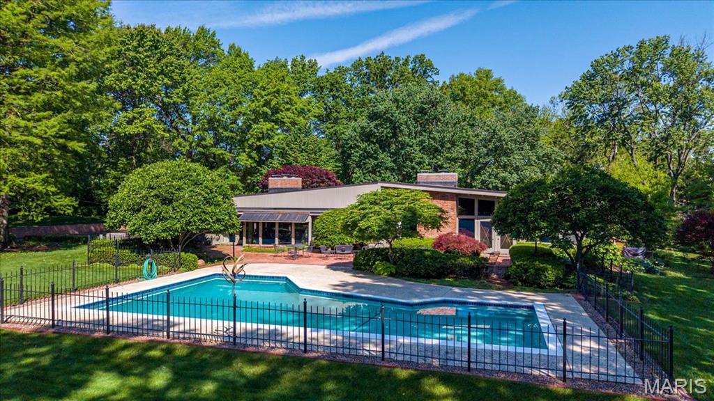 Designed by architect Isadore Shank in 1959, this Mid-Century Modern residence represents a period of architecture defined by simplicity, proportion, and a deliberate connection to its surroundings.

A long, tree-lined approach sets the tone, creating a sense of arrival that feels both private and intentional. The home unfolds through clean horizontal lines, expansive glass, and a layout that prioritizes natural light and a seamless relationship between interior spaces and the landscape beyond.

Carefully preserved over time, the home retains the integrity of its original design. Materials, scale, and sightlines remain consistent with the architectural intent, offering a living experience that feels both authentic to its era and relevant today.

The rear elevation is defined by walls of glass that open to brick terraces and a concrete pool, with outdoor spaces designed as a natural extension of the home rather than an addition to it. Mature trees and established landscaping create a setting that enhances both privacy and the overall architectural composition.

Situated on a private lot of approximately 2 acres, the property offers a scale and setting that is increasingly difficult to replicate. In a market where many properties are reimagined over time, this residence presents a different opportunity rooted in preservation, architectural significance, and the ability to experience a home as it was originally intended.

At the same time, the size and setting of the lot contribute to the long-term value of the property, offering flexibility for a range of future considerations.

Single-level living includes 4 bedrooms & 3 full baths, with a layout that remains functional while true to its original design.

A rare offering for those who recognize the distinction between a home that has been updated, and one that has been preserved with purpose.