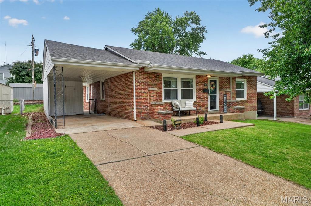 OPEN HOUSE CANCELLED!  Welcome home to this charming all-brick home in the heart of Boulevard Heights! Step inside and fall in love with the bright, open floor plan, gleaming hardwood floors, and incredible natural light throughout. The spacious layout flows effortlessly into the dining area, creating the perfect setup for everyday living and entertaining alike. The kitchen shines with stainless steel appliances, updated cabinetry, and gorgeous granite countertops ready for your next gathering, while the adjoining sunroom offers the perfect spot to enjoy your morning coffee, unwind with a book, or soak in views of the backyard year-round.  Each bedroom offers generous space and flexibility for ideal furniture placement, while the beautifully updated hall bath adds the perfect finishing touch. Downstairs, the finished basement is an entertainer’s dream featuring laminate wood flooring, a custom built-in bar, and an additional versatile room tucked behind stylish modern barn doors — perfect for a home office, gym, playroom, or guest space.  Step outside to a spacious backyard made for summer nights, backyard BBQs, relaxing mornings, and endless fun. Plus, you’re only blocks from the Great Rivers Greenway walking and biking trail! With windows updated in 2022 and charm at every turn, this home is move-in ready and packed with personality. Don’t wait — homes like this don’t stay on the market for long!