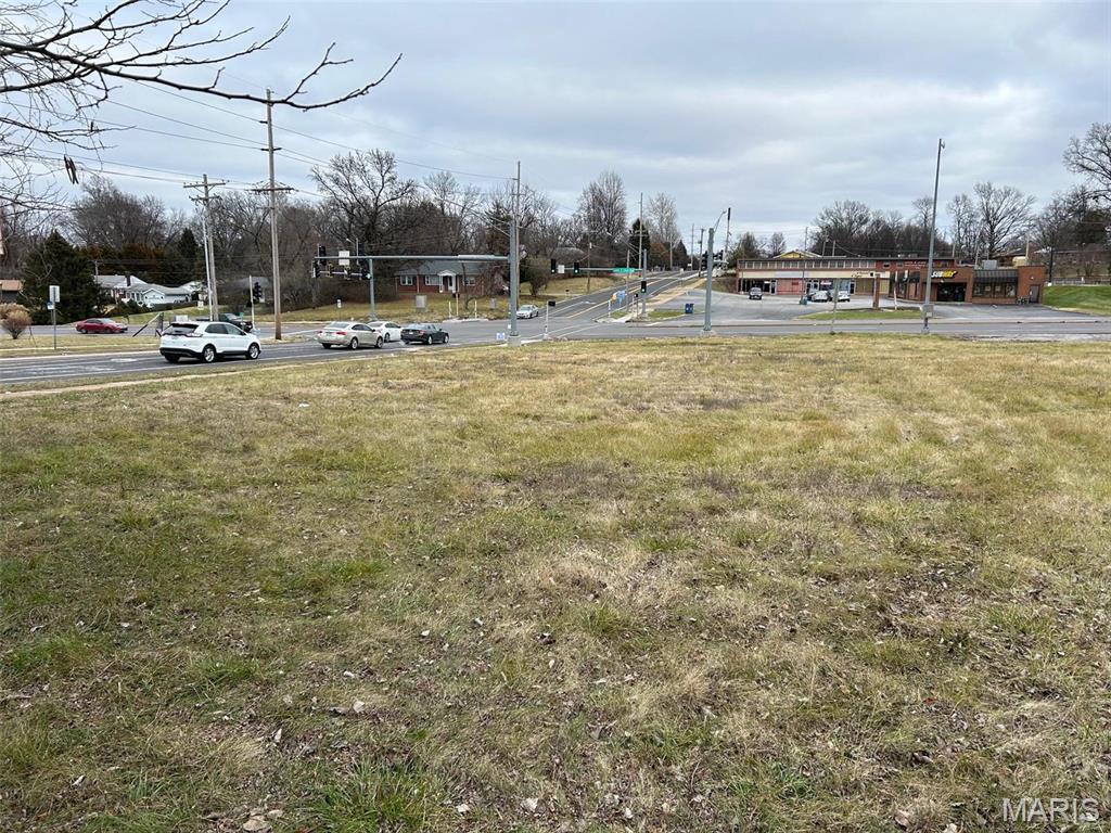 .88+/- acres of prime commercial property. 
Are you looking for a great signalized high traffic hard corner location for your restaurant, car wash, strip center, or next office building?  This property provides 145+/- feet of frontage along St. Cyr Rd & 258 feet along Lewis & Clark allowing for strong visibility and access from both Lewis & Clark and St. Cyr Road.  Owner would also consider a ground lease.  There is also the potential to utilize a TIF for this property.  Please check with the city of Jennings.  Owner will survey off .88 acres.  See also listings 26029703 and 26002878.

The City of Jennings, Missouri is located in North St. Louis County, about 20 minutes north of Downtown St Louis via Interstate 70 and Highway 367. Major thoroughfares for the community are Halls Ferry Road, Highway 367/Lewis and Clark Blvd. and Chambers Road.  North County is home to Lambert-St. Louis International Airport, Boeing's Defense, Space & Security unit, Emerson Electric Company, and Centene. Location: Corner Location, High Traffic, Hwy/Interstate Frontage