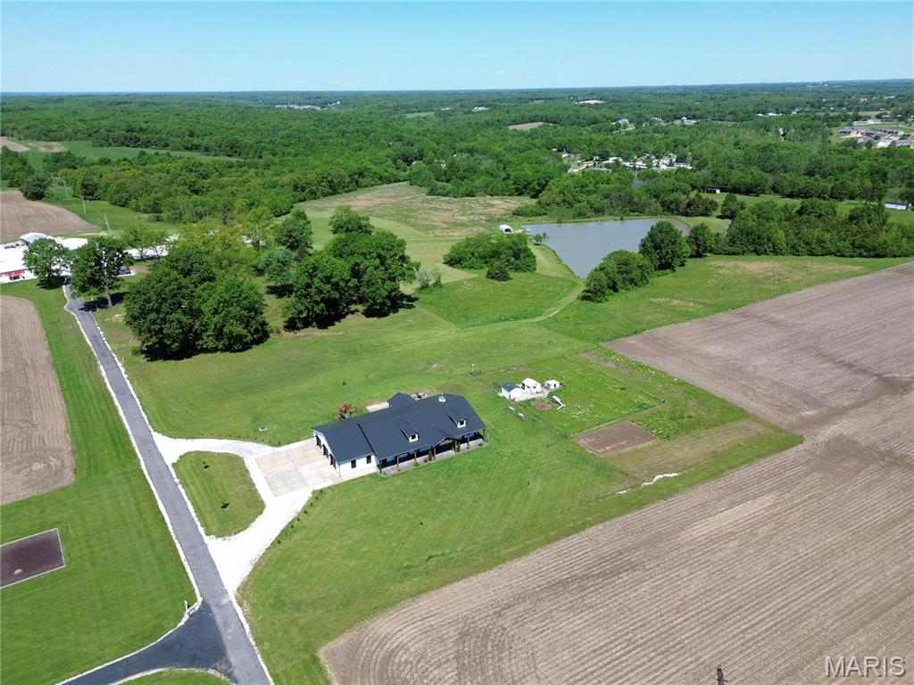 Exquisitely designed, built and finished 3300 sf main level fully custom ranch on 3 acres. 4 bedrooms, (5 if you count office) and 3 full baths.   This one MUST BE SEEN IN PERSON !!!! I cant find a detail that was overlooked on this home.  You will feel that when you walk up to the large front porch that spans the entire front of home.  Vaulted ceiling with t and g finishes.  The 8' front door sets the mood for the rest of your tour.   Open/Lodge-feel floorplan.  10 foot sidewall built from 2 x 6's.  Interior doors are 3 foot by 8 foot solid wood, and they are elegant looking without being ostentatious.  The kitchen is an absolute joy to cook and entertain in.  Massive island makes great gathering, prep areas, casual dining, outlets placed well for entertaining.  Gas range/grill are top notch as well as industrial ventilation hood.  Double fridge/freezer allows you to stay organized and plenty of space for a small army !!!  The large butlers pantry is nice enough to set up residency and organized better than the Emmy's award show.  The custom hickory cabinets really pop against the stained concrete floors that are heated !  The cathedral ceiling is finished in toungue and groove wood and the stain gives warmth and rustic class to the entire area.  Floor to ceiling stone fireplace is oversized for effect as well as supplying warmth and ambiance.  The 7 ton Geo-thermal unit doesn't need the help as it is the Mercedes Benz of HVAC.  The insualating package on this home is superb.  It has 3'' inch closed cell spray foam, r13 batts to fill the balance of the 2 x 6 walls.  No expense was spared on windows or doors.  Anderson series 400 windows and patio doors.  The dining kitchen and living room are all connected to each other and compliment each other soooo well.  The mudroom area is set for real everyday living and then some.   Custom cubby and coat rack is great, but the built in raised dog wash and grooming area just tops it all off.   The primary bedroom is large and cozy at same time.  Custom cabinet quality shelving and storage in primary closet.  dual vanities, free standing soaking tub and large walk in shower.  2 bedrooms share a jack n jill bathroom that is finished to the nines.  The office has a closet and is sized appropriately to be bedroom number 5 if you needed.  The laundry room makes doing laundry a joy, not a task.  It adjoins the mudroom and is also accessible thru the primary bedroom closet.  The exterior set up well for entertaining with "miles' of well placed concrete including integrated firepit area.  You will have an amazing view of some of the prettiest farm ground in Southern Lincoln County as well as your own fenced in chicken coop area that is adorned with wild flowers.  Large garden is tilled up and ready for your plantings if you hurry.   The roof is even constructed of standing seam steel which has an amazing warranty.  Sorry so long on the description, but you truly have to see this one and I know that I have left something out !!!!