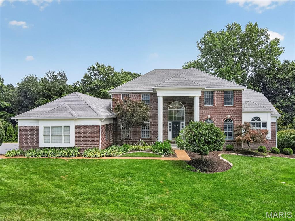 Welcome to this exceptional 1.5-story home in highly sought-after Pine Creek, offering over 5,600 square feet of beautifully finished living space with 5 bedrooms and 4.5 baths. Designed with an open, light-filled floor plan, this home showcases quality craftsmanship, custom millwork, hardwood floors, and numerous updates throughout. A dramatic two-story foyer welcomes you and opens to elegant formal living and dining rooms. The soaring great room features a beautifully renovated gas fireplace with custom millwork, new gas logs, and doors, creating a warm and inviting gathering space. The adjoining wet bar leads to the gourmet kitchen, complete with a center island, Corian countertops, custom white cabinetry, walk-in pantry, planning desk, stainless steel appliances, and a bright breakfast room with a Pella sliding door opening to the deck and the outdoors. Just beyond, the sunroom features a stunning tree-top view of the backyard and is surrounded by walls of windows equipped with retractable shades, providing the perfect space to relax year-round. The expansive main level also features a vaulted primary suite with a luxurious, fully renovated bath showcasing high-end finishes, marble flooring, dual adult-height vanities, a soaking tub, spacious walk-in shower, and generous walk-in closets. An updated powder room and a well-appointed laundry room with cabinetry and utility sink complete the first floor. The T-shaped staircase leads to a versatile loft ideal for a home office or study area, along with three spacious secondary bedrooms. Two bedrooms share an updated Jack-and-Jill bath, while the third enjoys its own beautifully updated private bath. The professionally finished walk-out lower level expands the living space with a large family room featuring a gas fireplace with new logs and doors, an expansive recreation area with a custom lighted bar accented by built-in bookcases, and a wine refrigerator. A den or flexible sleeping area, an updated full bath, and a fifth bedroom with a cedar closet make this level ideal for guests or multi-generational living. Additional highlights include newer carpeting, plantation shutters, professional landscaping, an irrigation system, and a 3-car side-entry garage. Located in the award-winning Rockwood School District, this impressive home combines timeless elegance, thoughtful updates, and exceptional living spaces in one of the area's most desirable neighborhoods!