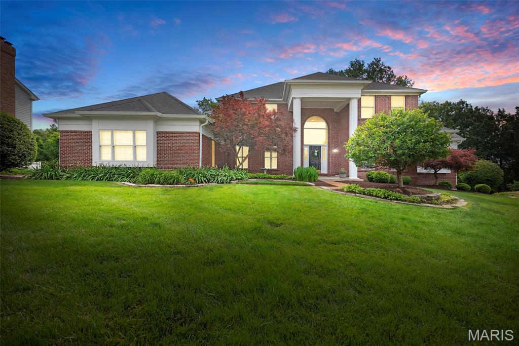 Welcome to this exceptional 1.5-story home in the highly sought-after Pine Creek subdivision, offering over 5,600 square feet of beautifully finished living space with 5 bedrooms and 4.5 baths. Designed with an open, light-filled floor plan, this home showcases quality craftsmanship, custom millwork, hardwood floors, and numerous updates throughout. A dramatic two-story foyer welcomes you and opens to elegant formal living and dining rooms. The soaring great room features a beautifully renovated gas fireplace with custom millwork, new gas logs, and doors, creating a warm and inviting gathering space. The adjoining wet bar leads to the gourmet kitchen, complete with a center island, Corian countertops, custom white cabinetry, walk-in pantry, planning desk, stainless steel appliances, and a bright breakfast room with a Pella sliding door opening to the deck and the outdoors. Just beyond, the sunroom is surrounded by walls of windows and equipped with retractable shades, providing the perfect space to relax year-round. The expansive main level also features a vaulted primary suite with a luxurious, fully renovated bath showcasing high-end finishes, marble flooring, dual adult-height vanities, a soaking tub, spacious walk-in shower, and generous walk-in closets. An updated powder room and a well-appointed laundry room with cabinetry and utility sink complete the first floor. The T-shaped staircase leads to a versatile loft ideal for a home office or study area, along with three spacious secondary bedrooms. Two bedrooms share an updated Jack-and-Jill bath, while the third enjoys its own beautifully updated private bath. The professionally finished walk-out lower level expands the living space with a large family room featuring a gas fireplace with new logs and doors, an expansive recreation area with a custom lighted bar accented by built-in bookcases, and a wine refrigerator. A den or flexible sleeping area, an updated full bath, and a fifth bedroom with a cedar closet make this level ideal for guests or multi-generational living. Additional highlights include newer carpeting, plantation shutters, professional landscaping, an irrigation system, and a 3-car side-entry garage. Located in the award-winning Rockwood School District, this impressive home combines timeless elegance, thoughtful updates, and exceptional living spaces in one of the area's most desirable neighborhoods!