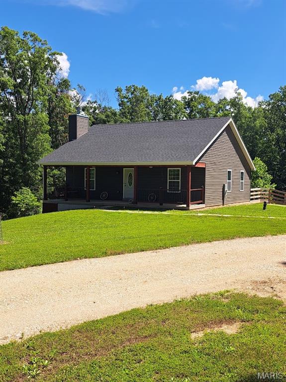 Wow! Discover the ultimate blend of modern living and peaceful country seclusion in this very nice, well-maintained, and comfortable four-year-old ranch. Nestled on 8.5 mostly wooded acres, this single-story home offers unmatched privacy and a front-row seat to nature. Inside, the bright and airy open-concept floor plan seamlessly connects the living spaces, creating a warm, welcoming environment featuring a nicely sized family room with a functional fireplace, a beautiful kitchen with a center island and granite countertops, two comfortable bedrooms, and two full bathrooms. The expansive, fully fenced backyard is perfect for pets, gardening, or outdoor play. Need more space? The walkout lower level offers incredible potential to expand your living area or to design the ultimate recreation room. It also has a rough-in full bath and plenty of storage areas. Nearby, there is a well-built woodshed and a 17x21 outbuilding that is perfect for any kind of shop. For you sportsmen, there are well-established ATV trails throughout the wooded property area, and this property is also within walking distance of the nearly 3,000-acre Missouri Department of Conservation "Little Lost Creek Conservation Area”. Don't miss this rare opportunity to own a nearly new home with acreage and endless possibilities. Make an appointment for a private showing as soon as possible, as this won’t last.