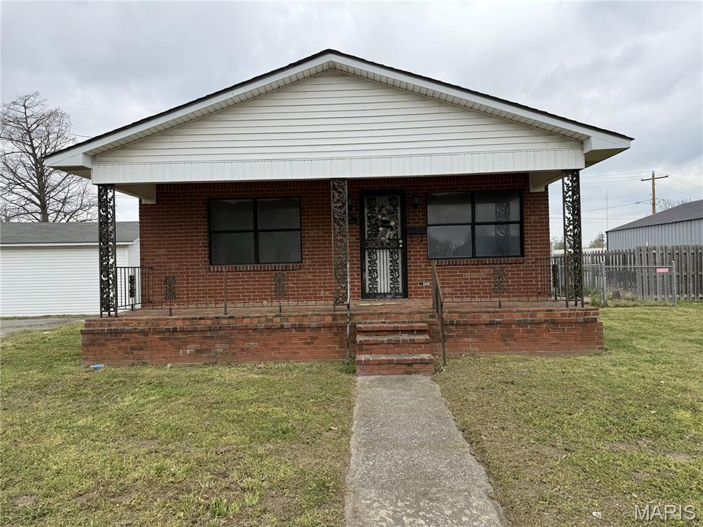 Back on market through no fault of seller. Very unique opportunity, "just a stone's throw" just across the street to both middle and high schools. This brick home with over 1400 SF, offers 3 bedrooms, and 1 bath. The floor plan has split bedrooms with one in the front end off the living room, and 2 others off the large den and utility, as well as the centrally located bath, kitchen, and dining room. The pie shaped sizable lot is zoned "B1" so you can open a small business right in the center of town if you so desire.  Besides Ward Ave, there is a side street running right behind the yard to allow you two entrances/exits. The home is move in condition so you can live there while you make it your own taste. Additional features include Central Heat and Air, appliances in the kitchen, great front porch, and 2 sheds, one with electric. Your kids will love walking just across the street to school!  Get creative with this one of a kind opportunity!