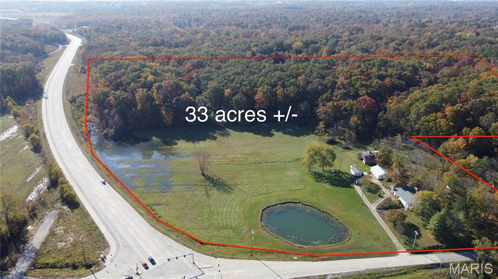 33 m/l Acre Development Tract – Unrestricted Potential at Poplar Bluff’s Edge-
An unparalleled opportunity awaits to invest in 33.23 acres of strategic, mixed-use land situated at the highly visible corner of Shelby Road and Roxie Road in Poplar Bluff, Missouri. This property is positioned for immediate, large-scale development and offers a rare combination of superior location and unrestricted flexibility.

Ultimate Development Advantage: This acreage adjoins the city limits, ensuring that municipal utilities are readily available for future connection. Crucially, there are no known restrictions of record (buyer to verify all intended uses), providing maximum flexibility for a developer to execute their vision without the constraints of a traditional HOA. Access is excellent, and the location benefits from high traffic counts, with close proximity to US Highway 67 (soon to be Interstate 57) and the Poplar Bluff Regional Airport. Three-phase power is readily available off Shelby Road, simplifying utility connections for major projects.

Defined Investment Zones: The 33.23 acres offers a split-use strategy:

Approximately 10 acres are primed for high-visibility commercial development at the main intersection.

The remaining 23 acres are ideally suited for necessary residential or multi-family housing, addressing the growing demand in the area.

The property includes an existing structure ( a farmhouse built in 1932), which offers potential as a temporary office, residence during construction, or a source of immediate rental income. This is a crucial investment for any developer, builder, or business looking to capitalize on Poplar Bluff's expanding infrastructure. Don't miss this phenomenal opportunity to acquire unrestricted land with city utilities and maximum future value.