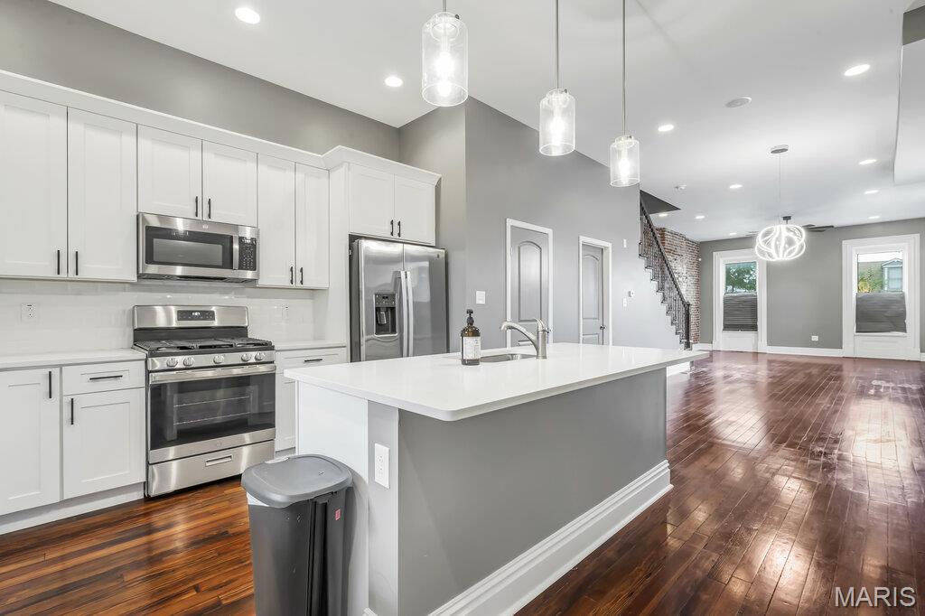 This beautifully restored 3-Bedroom, 4-Bath townhome offers over 2,600 square feet of living tucked away on a quiet one-way street in the heart of St. Louis City-blending historic St. Louis character with modern updates. Inside you will find exposed brick walls, rich hardwood flooring, and abundant natural light creating a warm and inviting atmosphere.
The heart of the home is the updated kitchen featuring granite countertops, custom 42-inch cabinetry, and stainless-steel appliances, all opening to the main living area. Upstairs, you find 2 spacious bedrooms both with full ensuite baths.  The primary bedroom has a walk in closet and private deck. The finished third floor offers endless possibilities as a media room, guest suite, creative studio, or private retreat with another private deck overlooking the city. Outside, the fully fenced backyard and covered carport provide the convenience and privacy that are increasingly hard to find in the city. The walkout basement offers additional expansion potential, giving future owners the opportunity to create even more living space tailored to their needs.  This beauty is located just moments from Tower Grove Park, the Missouri Botanical Garden, popular restaurants, and downtown St. Louis, offering a combination of historic charm, modern functionality and future potential.  As an added bonus, this townhome has NO HOA and qualifies for up to $40,000 in assistance with Home STL and up to $5,000 with Guild Gateway!  Qualified Buyers May Also Take Advantage of an Assumable VA Loan!   This Home Is Being Sold AS IS.
Enjoy your tour!