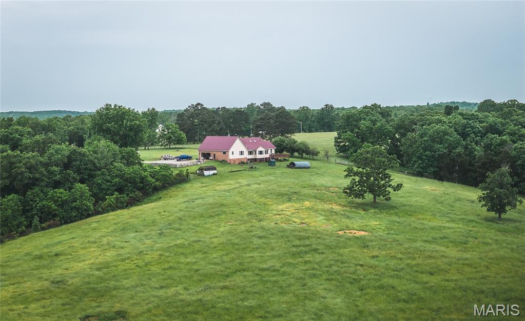 Take a look at this 485 acre working cattle ranch, with over 400 acres of pasture and hay ground that is  fenced and cross fenced with Barbed wire good gates and automatic freeze proof waterers to maximize the number of cattle that can be ran on this Ranch. The pasture are well maintained and regularly fertilized. there are several pastures that are being hayed, and a brand new 40 x 100 Hoop barn capable of storing over 400 round bales. In addition there is a big set of working corrals and a fenced alleyway making it easy to work cattle. Big Grass Farms of this quality are becoming harder and Harder to find especially ones of this quality that is ready to go to work for you. This place has enough mature timber on it to make great habitat for wildlife, there are loads of Deer and Turkey, and enough space for Hunting for all of your friends and Family. The nearly 3000 square foot Ranch  House sits on a knoll with a sunroom on the back with an awesome view of the valley overlooking a large part of the ranch. This well maintained home features 4 bedrooms 2 and a half bathrooms, a large eat-in kitchen, A fireplace and whirlpool tub. The  Yard is beautifully landscaped and the Home is well maintained, There is a 2 car attached  garage plus a large concrete parking area. Fenced and cross fenced into 14 separate pastures for easy rotational grazing and ready to go to work. If you're are a Sure enough Cattleman this is your kind of place.