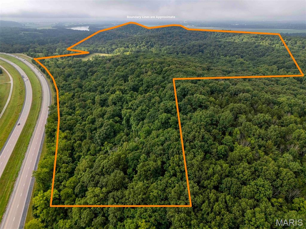 Opportunities to own a large, contiguous tract along the Missouri River are extremely rare. This 406 m/l-acre farm sits in an outstanding location just 10 minutes north of Jefferson City and 15 minutes south of Columbia, with convenient access to Highway 63. Public utilities are available on-site, including county water, electricity, and natural gas.

The property features a continuous ridgeline paralleling the river, offering building sites with sweeping views. Whether you envision a private estate, hunting lodge, development, or long-term investment property, the setting provides both privacy and accessibility in the heart of Mid-Missouri.

A well-established trail system winds through the property, connecting open fields, mature hardwood timber, and seasonal creek corridors. These trails make the farm highly usable for horseback riding, hiking, or UTV access throughout the property. The open areas could easily support horses, food plots, or a small herd of cattle while still maintaining the farm’s strong recreational appeal.

The wildlife habitat is excellent. The mix of timber, edge cover, and river-bottom habitat provides ideal conditions for deer and turkey, with abundant signs throughout the property. Approximately 15 acres of bottom ground sit beneath towering cottonwoods, along with a few acres of tillable ground that could serve as productive food plots or small crop acreage. The property includes a pavilion and several small hunting cabins that provide a comfortable base for family gatherings, hunting camps, or weekend retreats.

One of the property’s most unique features is its direct border with the Katy Trail. A wide access trail leads from the ridge tops down to the trail corridor, allowing owners to step directly onto one of Missouri’s most iconic recreational assets. Missouri River access further enhances the property’s recreational value.

Large tracts in this location are rare. With its combination of river views, diverse terrain, established improvements, and proximity to both Columbia and Jefferson City, this property offers a unique opportunity to own a large tract along the Missouri River.