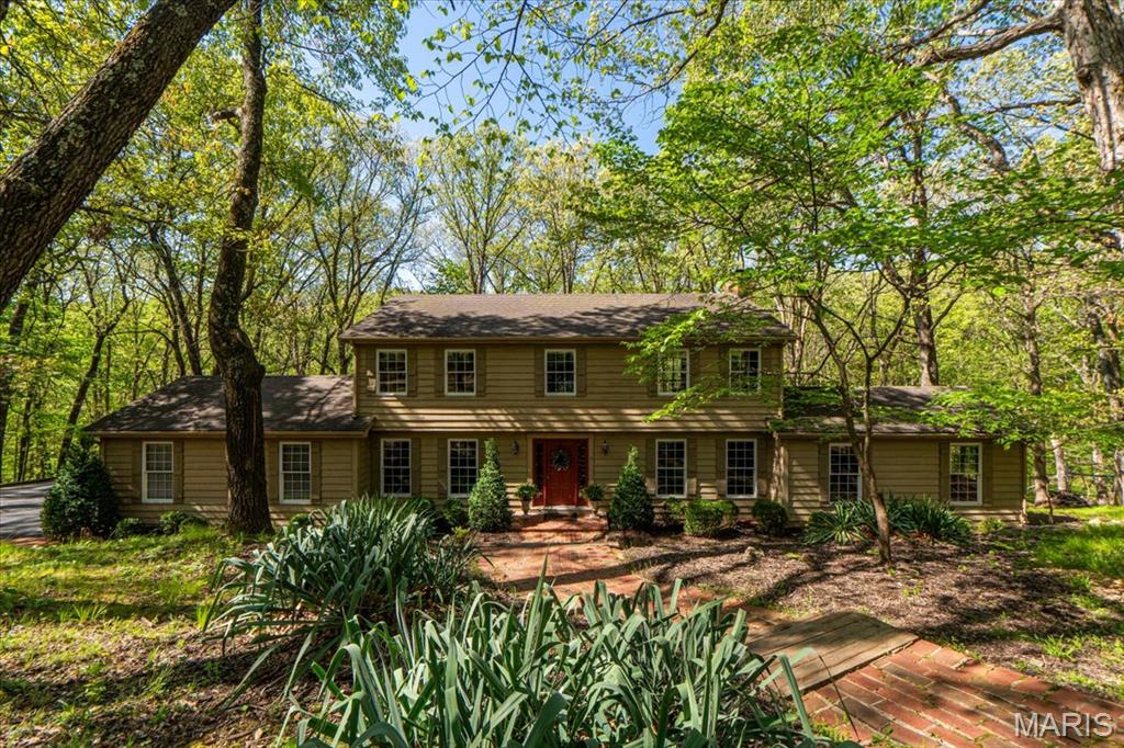 Incredible opportunity to own this beautiful custom 2-story home in the highly sought-after Indian Tree subdivision, perfectly situated just off a quiet cul-de-sac on 3.09+/- secluded acres with breathtaking wooded views and complete privacy. Enjoy the best of both worlds: a peaceful, private retreat conveniently located close to dining, entertainment, and shopping. This home offers an amazing setting, abundant living space, and endless potential and priced to sell FAST! Step inside and immediately appreciate the spacious layout featuring a large living room with a wet bar and cozy wood-burning fireplace, perfect for entertaining or relaxing evenings at home. The stunning study showcases a coffered ceiling, custom built-in bookshelves, and exceptional millwork that creates an elegant and inviting workspace. The heart of the home is the expansive kitchen and breakfast room combination, offering incredible space for gatherings, everyday living, and entertaining. Just off the kitchen, step out onto one of three private decks overlooking the lush woods and peaceful backyard setting. Upstairs, the primary suite offers a private sitting area and its own deck retreat where you can enjoy complete serenity and nature views. The second floor also includes three additional spacious bedrooms and a full bath, providing plenty of room for family and guests. The professionally finished lower level is filled with natural light from numerous windows and two French doors leading to the beautifully landscaped backyard. This level also features a spacious rec room with a second wood-burning fireplace, dry bar with beverage fridge, 5th bedroom, full bath, and private office with exterior access, ideal for guests, work-from-home space, or multi-generational living. Additional highlights include an extra-large garage, three private decks, beautiful wooded surroundings, and a floor plan designed for comfortable living and entertaining. This is a rare chance to own a private retreat in an incredible location — don’t miss it!