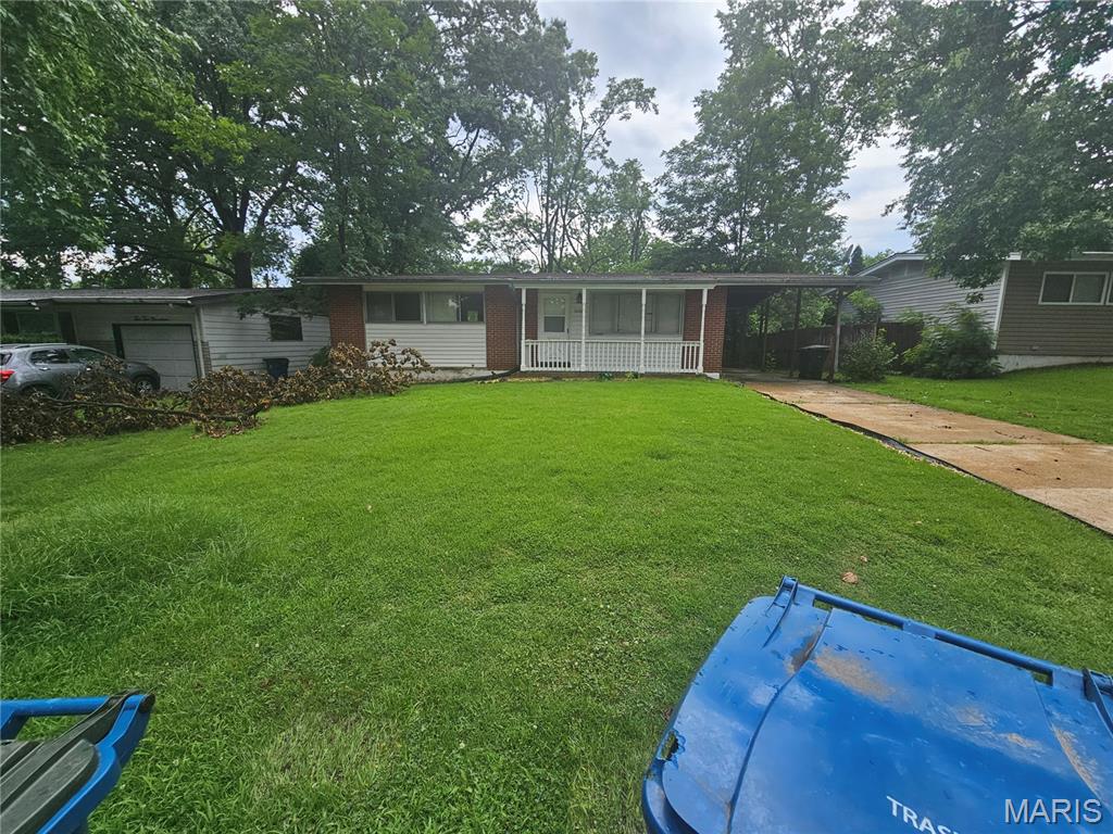 Welcome to 10223 Reba Dr, a charming single-story ranch home located in the heart of St. Louis County. Featuring 3 comfortable bedrooms and 1 bathroom across 1,014 square feet of intelligent living space, this residence pairs classic architectural bones with real functional value.  The main level boasts an inviting flow with fresh carpeting and clean 6-panel doors throughout. A standout highlight of this property is the newly finished lower level, offering a versatile bonus area perfect for a family room, home office, or hobby space.  Outside, the level lot features a convenient carport and plenty of room for outdoor activities. Situated in a quiet, established neighborhood, you're just minutes from local schools, parks, and major transit routes.