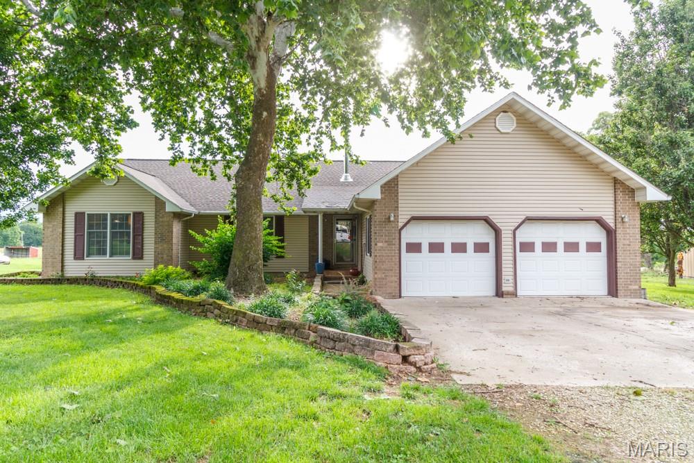 Welcome to your own private slice of paradise! Nestled on 22 acs m/l, this beautifully maintained property offers the perfect blend of comfort, functionality, & rural charm. Whether you're dreaming of a hobby farm, homestead, or simply a peaceful retreat, this property delivers. As you enter the drive, you'll be welcomed by mature shade trees, fruit trees, colorful flower beds, a stately flagpole, & a charming brick/vinyl home that exudes pride of ownership. Inside, you'll find 1,834 sq. ft. of thoughtfully designed living space featuring a desirable split-bedroom floor plan with 3 bedrooms, 2 full bathrooms, and an attached 2-car garage complete with an epoxy-coated floor. The primary suite is a peaceful retreat on the opposite side of the home with ensuite bathroom that has a stand up shower and a separate tub. The home offers several standout features, including a hall closet that doubles as a coded gun safe and a recently installed Vermont Castings Encore wood stove, providing both warmth and rustic character. Step out onto the back deck and take in the breathtaking views of rolling pasture, abundant wildlife, spectacular sunsets, & the large pond that serves as the centerpiece of this picturesque property. Ready for livestock, equipment, & farm life, the impressive 50' x 60' barn features a gravel floor & ample space for hay, feed, & machinery storage. A dedicated room with water, sink, & counter space provides the perfect setup for livestock care, farm projects, or bottle feeding. Horse lovers will appreciate the opportunity to easily add stalls & customize the space to fit their needs.
Additional outbuildings include a 20' x 12' storage building with a concrete floor, ideal for a workshop, hobby space, lawn equipment, or the ultimate retreat, as well as an additional 8' x 12' storage shed for even more versatility. The fenced acreage includes an established garden area, chicken coop, mature trees, abundant wildlife, & a beautiful pond, creating an ideal environment for sustainable country living. Numerous updates provide peace of mind, including a new roof in 2021, new siding installed in 2023, a new exterior HVAC unit in 2021, and new flooring throughout the home. Properties offering this combination of acreage, improvements, modern updates, & breathtaking scenery are increasingly hard to find. Schedule your private showing today and experience all that this exceptional property has to offer! Appliances include a water softener, newer fridge, double oven, and a newer washer and dryer.