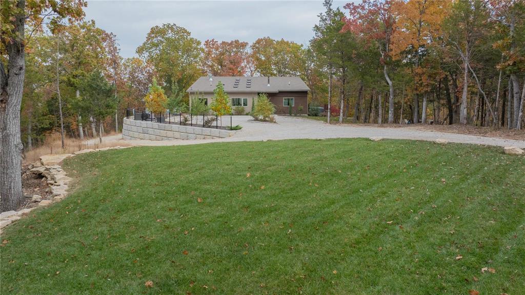 A Rare Sanctuary of Luxury and Tranquility. Own a one-of-a-kind estate—3,400 sqft of refined living on 35.94 secluded acres, just 20 minutes from St. Louis. An 18' x 10' wall of windows and eight skylights flood the home with natural light, seamlessly blending indoor and outdoor beauty. The great room stuns with a grand fireplace, elegant bar, and library. The chef’s kitchen boasts custom cabinetry, quartz countertops, and premium appliances.The main-floor primary suite is a private retreat with a spa-like ensuite, soaking tub, oversized shower, private balcony, and dedicated laundry. The lower level offers a secondary ensuite, two bedrooms, a family room, kitchenette, and two baths—perfect for children or guests. Surrounded by lush woodlands, this estate offers serenity and exclusivity.