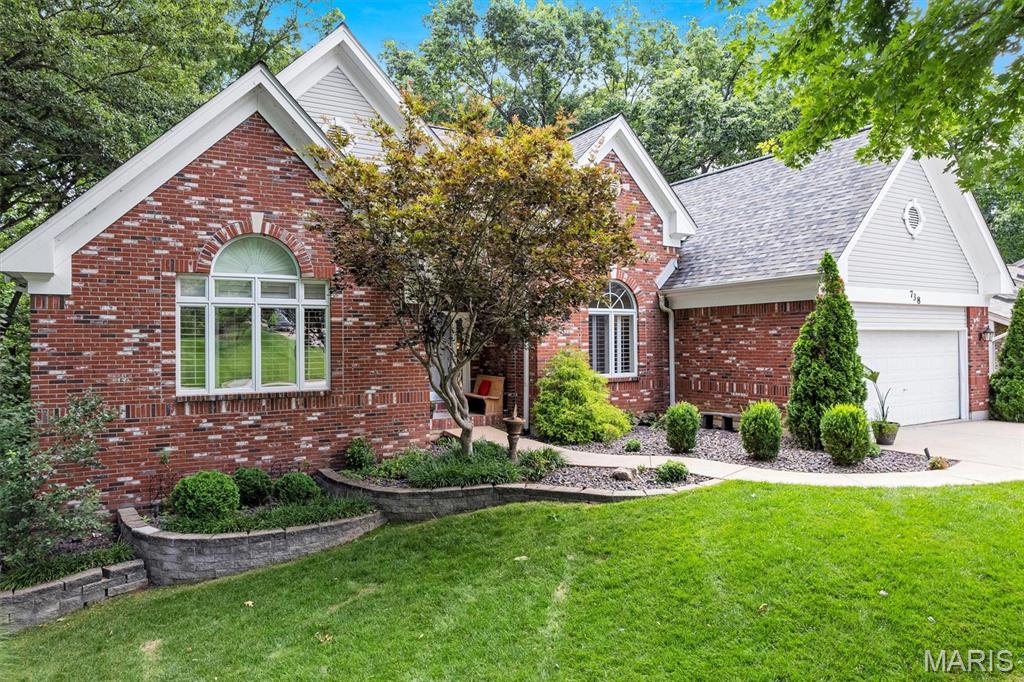 Welcome to 738 High Point Drive in the highly sought-after Lake St. Louis community! This beautifully maintained 4-bedroom, 3.5-bath ranch home offers over 3,600 square feet of living space, lake rights, exceptional curb appeal, and a private setting backing to mature trees.

From the moment you arrive, you'll appreciate the attractive brick-front exterior, covered front porch, extensive professional landscaping, irrigation system, and landscape LED lighting. Step inside to an open and inviting floor plan featuring soaring ceilings, abundant natural light, newer flooring, and quality finishes throughout. The formal dining room boasts impressive 14-foot ceilings, crown molding, and is perfect for hosting family gatherings or special occasions.

The spacious kitchen is designed for both entertaining and everyday living, featuring a large center island, breakfast bar, granite countertops, pantry, ceramic flooring, and a bright breakfast room surrounded by windows overlooking the private backyard. Convenient main-floor laundry is located just off the kitchen.

The vaulted primary suite serves as a relaxing retreat with a walk-in closet and luxury bath featuring double vanities, a whirlpool tub, and separate shower. The divided-bedroom floor plan provides privacy, with additional bedrooms and baths thoughtfully located on the main level.

The finished walkout lower level offers incredible additional living space, including a large family room with a wall of windows, a full second kitchen, a spacious fourth bedroom with walk-in closet, full bath, bonus room, and a separate side-entry door—ideal for guests, extended family, entertaining, or multi-generational living.

Outdoor living is truly exceptional with a large deck, covered patio, stamped concrete patio with firepit, and a private 4-person hot tub—perfect for relaxing after a long day or entertaining family and friends. The peaceful wooded backdrop creates a private oasis you'll enjoy year-round, and just a few short steps to the pathway leading to the lake and park area.

Additional updates and features include:
• Lake St. Louis Lake Rights
• New Architectural Roof
• New HVAC System (2019)
• Full Kitchen in Lower Level
• Walkout Basement
• Radon Mitigation System
• Irrigation System
• Professional Landscaping & LED Landscape Lighting
• Oversized Deck and Covered Patio
• Private Wooded Lot

This rare combination of location, space, updates, privacy, and lake amenities makes 738 High Point Drive a must-see. Schedule your private showing today!