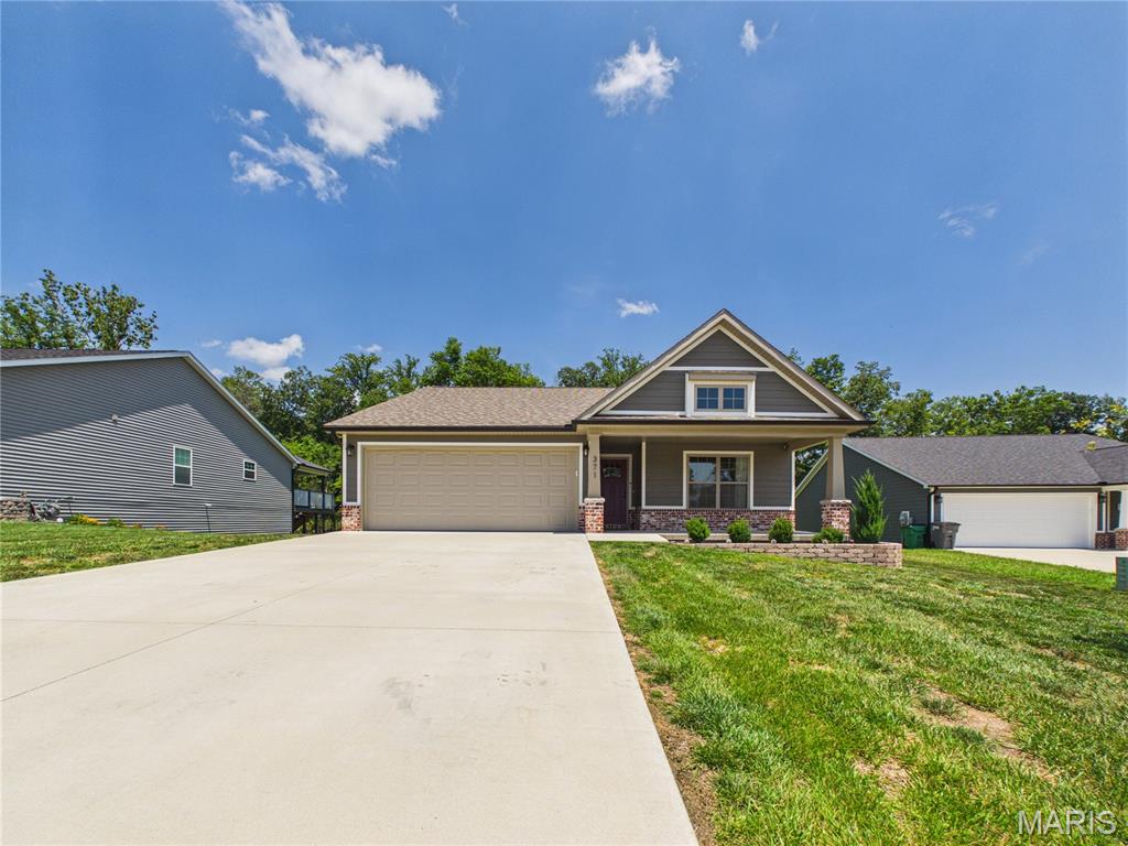 Welcome to this beautifully maintained craftsman-style ranch tucked away on a quiet cul-de-sac in Savers Farm Subdivision. This home features 3 bedrooms, 3 full bathrooms, and a finished walkout basement. 

Step inside to an inviting open floor plan designed for everyday living and entertaining. Just off the entry, you'll find two spacious bedrooms separated by a full bathroom that offers the perfect amount of privacy. Continue into the heart of the home where the kitchen shines with granite countertops, stainless steel appliances, a large center island, and plenty of space to gather.

Just off the dining area, sliding glass doors lead to a covered deck complete with a ceiling fan, overlooking the expansive, chain-link fenced backyard that backs to a peaceful wooded area—an ideal setting for relaxing or entertaining outdoors.

The primary suite is tucked away for added privacy and features a spacious walk-in closet and an en-suite bathroom with a double vanity and granite countertops. The laundry room is conveniently located on the main-level, just outside the primary suite. 

Downstairs, the finished walkout basement provides even more living space with a large room perfect for movie nights, game days, or entertaining. You'll also find a generous bonus room, a John Deere room for lawn equipment or workshop space, an additional unfinished storage area, and a third full bathroom. 

If you've been looking for a move-in ready home with a functional floor plan, quality finishes, extra living space, and a private backyard setting, this one is definitely worth seeing.