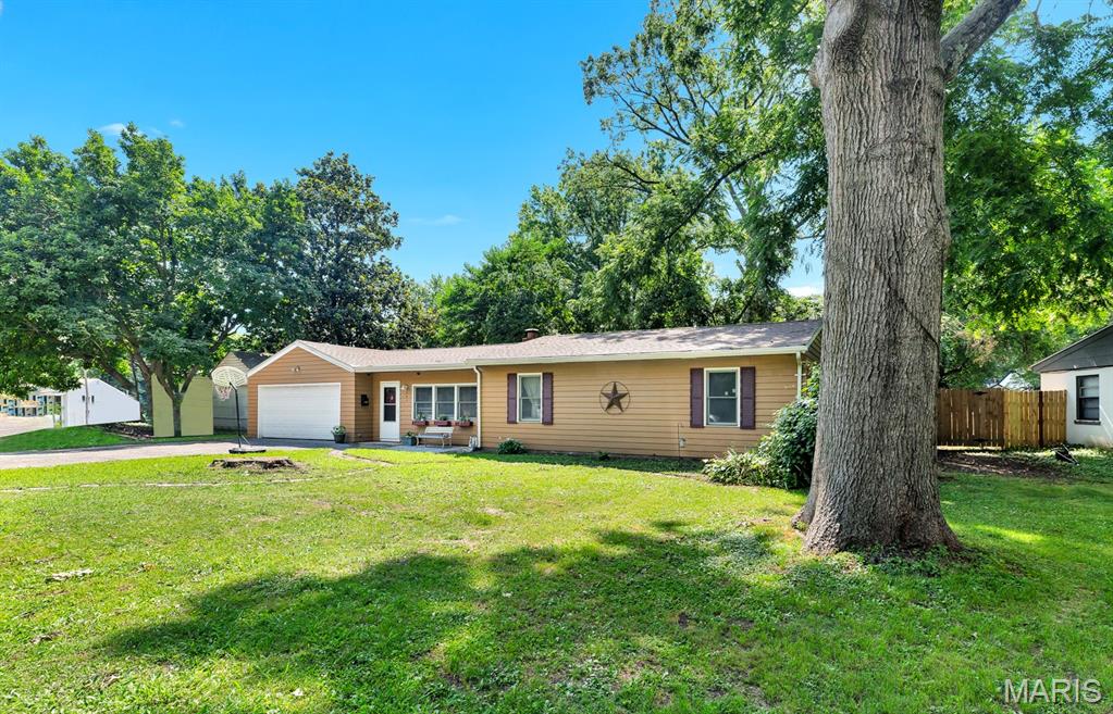 GREAT HOUSE - GREAT PRICE!  This beautiful 3 bedroom/1 bath property, flooded with natural light, is move-in ready. Your first step into the home impresses with a large, bright living area featuring a striking, wood-burning fireplace. And, it works. There is plenty of room for family and friends to gather to make memories and/or the new owner may create zones for games, a reading corner, or displays.  It's a little hot now for that fireplace, but you will appreciate the ambiance when Winter rolls around. A hallway leads to the three bedrooms and a really nice bathroom that includes a generously-sized closet area for storage. Take a few more steps to the breakfast room and striking updated kitchen.  (The stainless steel refrigerator will stay.)  Another space off the kitchen with access to the back yard serves as a utility and laundry room with new flooring. The breakfast nook leads to a spacious, newer, screened porch offering bonus living space with a view and entry to the wide back yard. The outside yard showcases a large deck for entertaining and a yard already filled with fun for kids. The space is fenced, but the fences belong to the neighbors.  Don't miss the oversized, attached two-car garage!

Shopping, highways, parks, and public transportation are conveniently nearby. The home is only blocks away from two major thoroughfares offering restaurants, bars, and the popular Ferguson Farmer's Market. 

Showings require preapproved buyers, only.