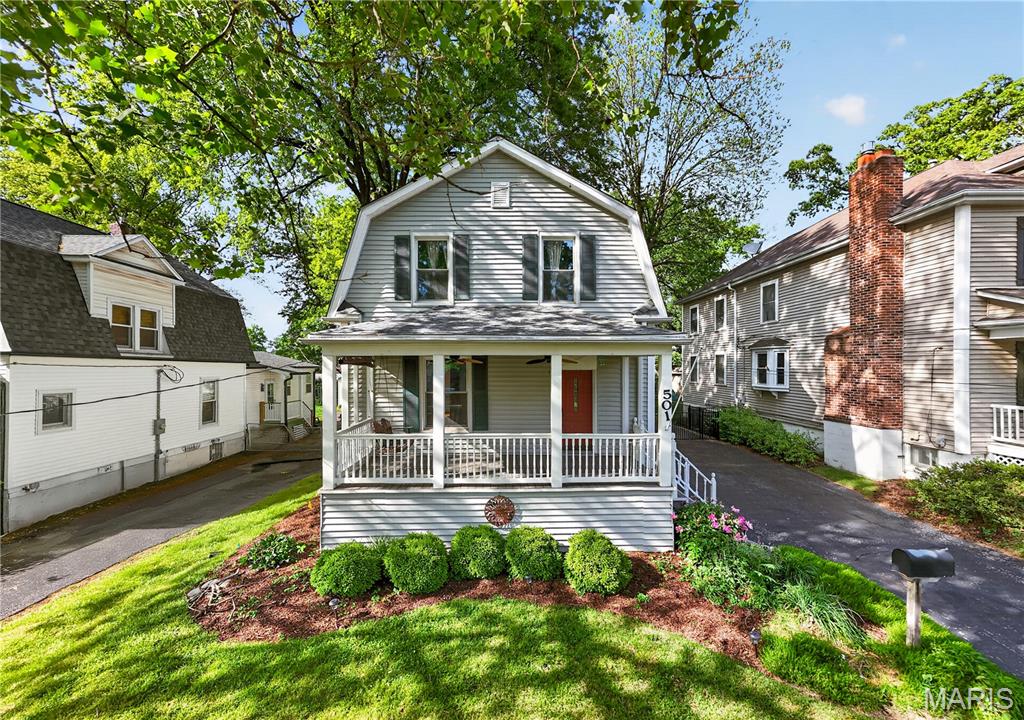 Tucked into the heart of beloved Tuxedo Park, 501 Clark tells the kind of story that makes Webster Groves so special — tree-lined streets, neighbors out walking, and a home filled with warmth and character. From the moment you step onto the welcoming front porch, you’ll feel the timeless charm that defines this classic 4-bedroom, 2.5-bath home. Inside, built-in bookcases frame the inviting living room, where conversations naturally flow into the gracious dining room, made for holiday dinners, birthday celebrations, and lingering evenings around the table. The kitchen is the heart of the home, featuring abundant cabinetry, a peninsula with seating, and a sunny breakfast area where friends and family can gather while meals are prepared. Just beyond, the expansive great room boasts soaring vaulted ceilings, skylights, a gas fireplace, and walls of windows that bring the outdoors in. Whether it’s movie night, game day, or a quiet morning with coffee, this is a space you’ll never want to leave. Rarely found in a traditional Webster home, the main-level bedroom and full bath offer flexibility and convenience for a variety of lifestyle needs. Upstairs, you’ll find three additional bedrooms and an updated full bath with a double-sink vanity and tub/shower combination. The walk-up basement includes storage, a half bath, and additional flex areas for a home office or recreation room. Outside, the fenced backyard has room for play and gardening, while the oversized two-car garage can accommodate vehicles, a workshop, and recreational equipment. Then there’s the neighborhood itself! Imagine daily strolls to Avery Elementary, weekend coffee runs to Maypop, and ambling to the shops and restaurants of Old Orchard. Life at 501 Clark is more than just a home — it’s an opportunity to become part of beloved Webster Groves, one of the area’s most cherished communities.