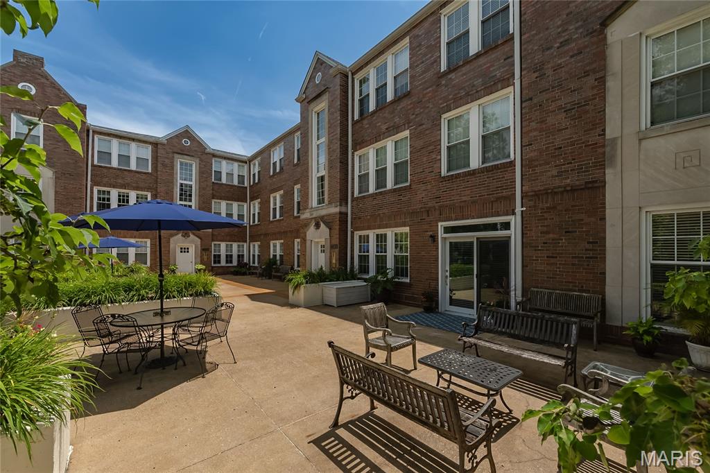 Welcome to this beautifully maintained 2-bed, 2-bath first-floor condo, offering expansive light-filled living space in one of Clayton's most desirable locations. Designed with an open floor plan, the spacious kitchen features a center island, abundant cabinetry, and opens seamlessly to the living and dining areas. Whether you are hosting friends or enjoying a relaxing evening at home, the open-concept layout offers the perfect balance of comfort and functionality. 

The inviting living room showcases a fireplace with built-in bookcases, while the generous dining area easily accommodates gatherings. The primary suite is a true retreat, complete with French doors leading to a private office or sitting room, a spa-like bath with soaking tub, separate shower, double vanity, and a large walk-in closet. The second bedroom also features a walk-in closet and direct access to the adjacent full bath. Unlike many units in the complex, the in-unit laundry is conveniently located in the hallway rather than the kitchen.

Additional highlights include hardwood flooring throughout the main living areas, updated laminate flooring in both bedrooms (2025), crown molding, recessed lighting, ceiling fans, window treatments, and access to a common area patio. Recent improvements include a new HVAC system (2022), professionally cleaned air ducts (2026), and HOA-completed roof repairs following the 2025 storm.

Enjoy low-maintenance living with an HOA-maintained exterior, two assigned garage parking spaces, and a private storage room. The unbeatable location places you in the heart of the Wydown Business District, just one block from Starbucks, Protzel's Delicatessen, restaurants, dry cleaners, and Wydown Park, with downtown Clayton, shopping, dining, and easy access to Highways 40/64 and 170 just minutes away.