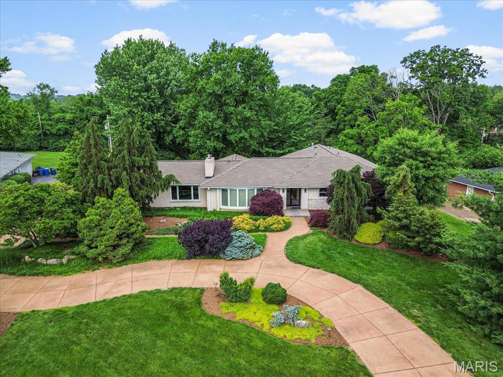 Amazing central location, great highway access, sits on 1 acre, lush garden ranch home. 4 bed/4 bath, includes 2 full master suites both with double sinks, separate jet tubs and showers. Finished walk out basement, with two storage rooms, full bath, game area, gym area and additional family room. Concrete circle driveway and a gardeners paradise, with over 40 mature, rare evergreen trees, exquisite hostas and speciality plants. Unique, contemporary home, with vaulted ceilings, updated kitchen, double see-through slate fireplace, 3 custom, built in lighted display walls for your artwork. Giant, level back yard awarded best of Creve Coeur for trees. Updated kitchen with sun filled breakfast room overlooking the gorgeous back yard. Large deck with gas grill and outdoor seating area. Kitchen has granite countertops, island, newer appliances and newer Renewal by Anderson windows. This dream home is ‘move in ready’ for a new family. Showings begin Thursday 7/16/2026