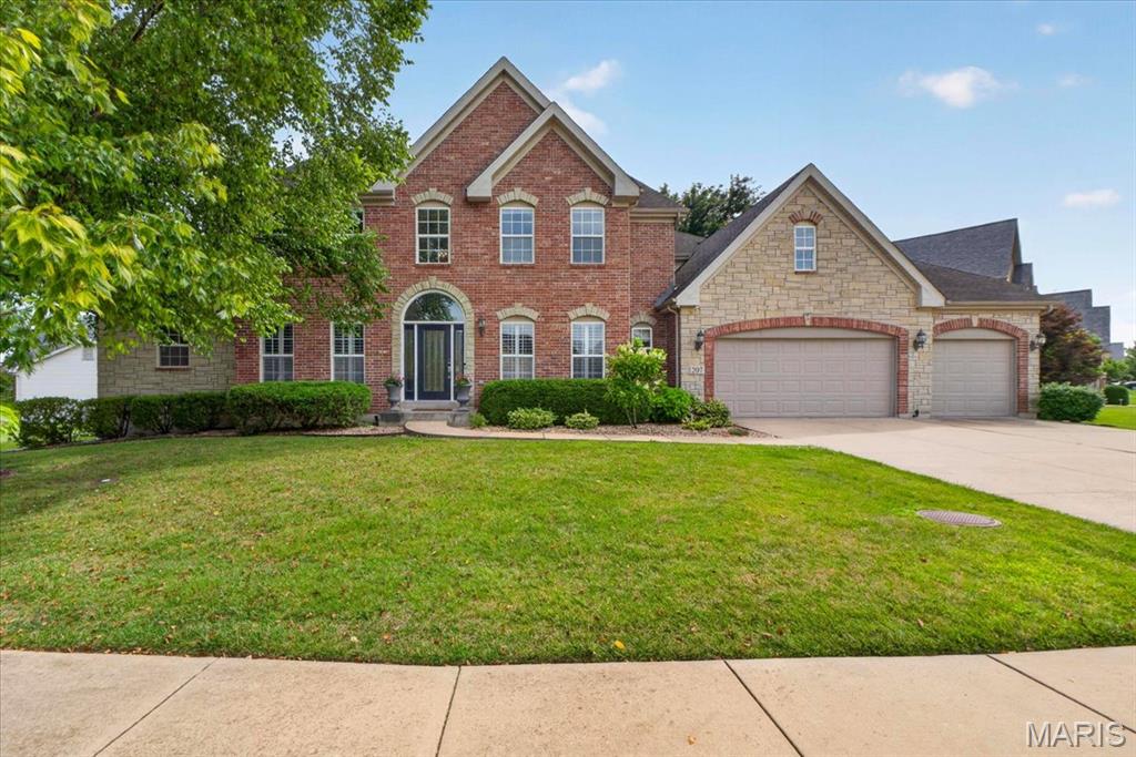 Welcome to 207 Irish Hound Drive in the sought-after Fox Haven community, where timeless design, spacious living, and a picturesque homesite come together in this beautifully maintained 1.5-story home complete with a 3 car heated garage and nestled on a fenced lot surrounded by mature trees. Offering 4 bedrooms, 4.5 bathrooms, and a partially finished lower level, this home blends everyday comfort with exceptional functionality. A dramatic two-story foyer welcomes you inside to an elegant Dining Room with Butler Pantry niche and versatile Living Room—ideal for hosting holiday gatherings, entertaining guests, or creating a sophisticated sitting area. The impressive two-story Great Room features a fireplace flanked by expansive windows, filling the space with natural light and creating a warm, inviting gathering place. A chef's kitchen serves as the core of the home, thoughtfully designed for everyday living. It features an oversized center island with seating, granite countertops, a tile backsplash, double ovens, and abundant cabinetry, while the walk-in pantry provides exceptional storage. The adjoining breakfast nook is surrounded by windows, filling the space with natural light and offering peaceful views of the private backyard. Overlooking the Great Room, the versatile loft provides the perfect setting for a media room, home office, study area, or playroom. The spacious main-level Primary Suite is a true retreat, with two walk-in closets complete with custom shelving and a spa-inspired luxury bathroom featuring upscale finishes, custom cabinets, freestanding tub and tile shower. A private bonus room tucked behind French doors creates a perfect space for a home office, nursery, or sitting room. Bedroom #2 offers a private en-suite bath and walk-in closet, while Bedrooms #3 and #4 share another full bathroom. The partially finished lower level expands your living options with an office, full bathroom, and media room featuring a convenient component closet. An abundance of space provides endless possibilities for future customization, whether you envision a recreation room, fitness studio, guest suite, or additional entertaining area. Outside, enjoy the stamped concrete patio and hot tub while overlooking the private, fenced backyard framed by mature trees, creating the perfect outdoor oasis. With its thoughtfully designed floor plan, expansive living spaces, quality finishes throughout, and endless opportunities for future expansion, this exceptional one-of-a-kind home seamlessly blends timeless elegance, everyday comfort, and lasting value.