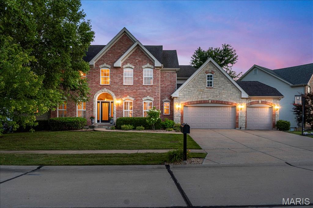 Welcome to 207 Irish Hound Drive in the sought-after Fox Haven community, where timeless design, spacious living, and a picturesque homesite come together in this beautifully maintained 1.5-story home complete with a 3 car heated garage and nestled on a fenced lot surrounded by mature trees. Offering 4 bedrooms, 4.5 bathrooms, and a partially finished lower level, this home blends everyday comfort with exceptional functionality. A dramatic two-story foyer welcomes you inside to an elegant Dining Room with Butler Pantry niche and versatile Living Room—ideal for hosting holiday gatherings, entertaining guests, or creating a sophisticated sitting area. The impressive two-story Great Room features a fireplace flanked by expansive windows, filling the space with natural light and creating a warm, inviting gathering place. A chef's kitchen serves as the core of the home, thoughtfully designed for everyday living. It features an oversized center island with seating, granite countertops, a tile backsplash, double ovens, and abundant cabinetry, while the walk-in pantry provides exceptional storage. The adjoining breakfast nook is surrounded by windows, filling the space with natural light and offering peaceful views of the private backyard. Overlooking the Great Room, the versatile loft provides the perfect setting for a media room, home office, study area, or playroom. The spacious main-level Primary Suite is a true retreat, with two walk-in closets complete with custom shelving and a spa-inspired luxury bathroom featuring upscale finishes, custom cabinets, freestanding tub and tile shower. A private bonus room tucked behind French doors creates a perfect space for a home office, nursery, or sitting room. Bedroom #2 offers a private en-suite bath and walk-in closet, while Bedrooms #3 and #4 share another full bathroom. The partially finished lower level expands your living options with an office, full bathroom, and media room featuring a convenient component closet. An abundance of space provides endless possibilities for future customization, whether you envision a recreation room, fitness studio, guest suite, or additional entertaining area. Outside, enjoy the stamped concrete patio and hot tub while overlooking the private, fenced backyard framed by mature trees, creating the perfect outdoor oasis. With its thoughtfully designed floor plan, expansive living spaces, quality finishes throughout, and endless opportunities for future expansion, this exceptional one-of-a-kind home seamlessly blends timeless elegance, everyday comfort, and lasting value.
