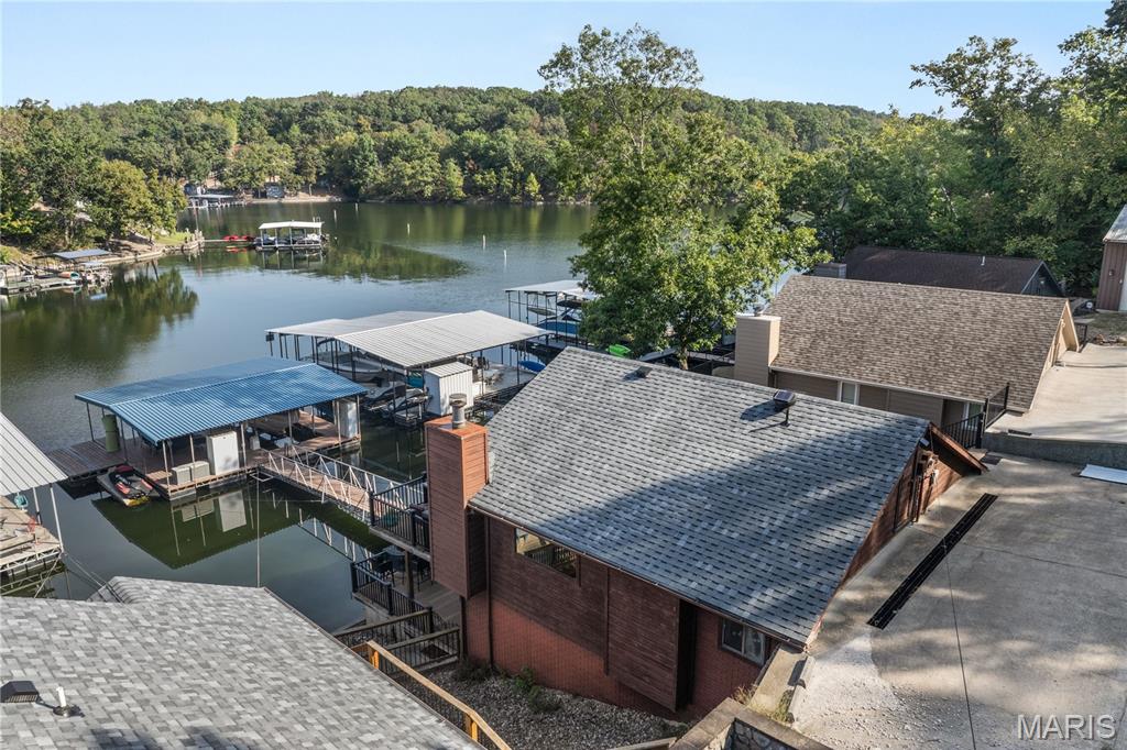 Experience lakefront perfection in this charming 3-bedroom, 3-bath ranch-style walkout in Sunrise Beach. Perfectly positioned at the 25 MM in a quiet, deep-water, no-wake cove, this home features gentle lot topography and wide lake views, making it an ideal full-time residence or vacation retreat. The main level boasts a bright open concept with beautiful hardwood floors, a cozy fireplace, Pella sliding doors, and a pristine Trex deck. The updated kitchen shines with granite countertops and modern finishes. Two comfortable bedrooms and two bathrooms complete the main floor. The lower level offers a private third bedroom and bath, alongside a spacious family room and laundry area. Ultimate peace of mind comes built-in, as the seller is currently in the process of installing a cutting-edge technology environmental discharge system, ensuring top-tier efficiency and modern compliance for years to come. Step outside to the large lower deck, where just three easy steps lead you to the dock walkway. The private 1-well dock features a swim platform and infinity steps (second well filled in but easily converted back). Additional highlights include a concrete parking pad for 4 vehicles ready for a future detached garage, an immaculate neighborhood, and quick access by land or water to top restaurants, Camdenton, and Lake Ozark. Don't miss this complete package! Don’t miss your chance to own this slice of paradise—experience it now via the fully interactive virtual tour!