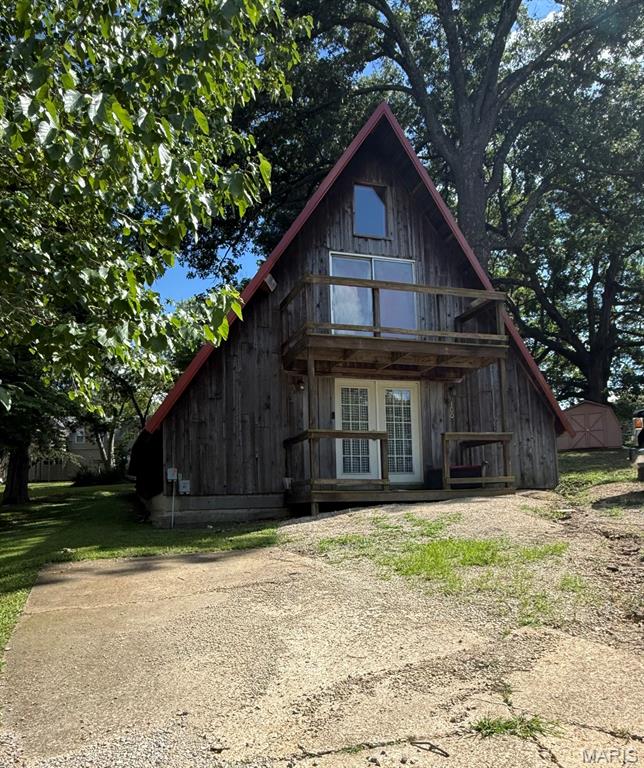 Welcome to this charming A-frame home in Bloomfield, MO, where character and comfort come together in a truly unique setting. This inviting home features a warm, cozy interior with an open layout that makes the most of every space. One of its standout features is the loft, complete with impressive sliding glass doors that flood the space with natural light and create the perfect place to unwind or enjoy the view. Conveniently located just down the street from the local park and golf course, you'll enjoy easy access to outdoor recreation while still being close to the amenities Bloomfield has to offer. If you've been searching for a home with distinctive architecture, inviting spaces, and a desirable location, this A-frame is one you won't want to miss. Schedule your private showing today and discover all the charm this Bloomfield property has to offer. Front photo coming soon.