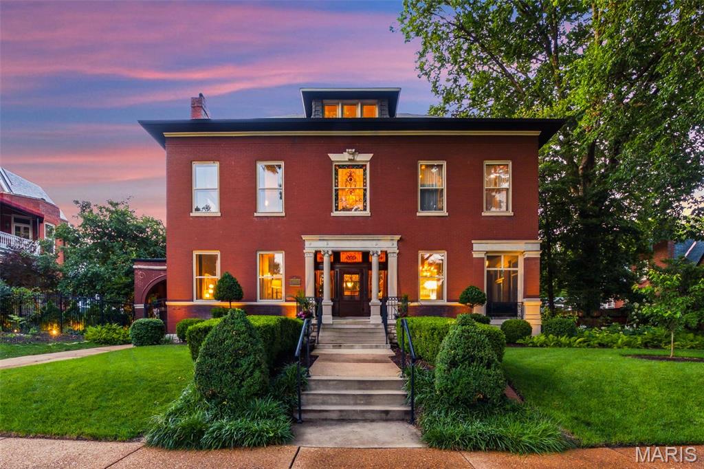Built in 1897 by Herman Huessler, this Classic Revival landmark in the heart of historic Compton Heights pairs century-old splendor with a meticulous, museum-quality renovation — backed by significant recent investment from the current owners. 5 bedrooms, 3.5 baths, plus a 2,500-square-foot carriage house, a rarity in this market. The chef’s kitchen anchors the main level with a 48” Wolf range(2023), a built in Sub-Zero refrigerator, two butler’s pantries, a wine cooler, and dual prep sinks. A grand staircase rises beneath a stunning art glass window, framed by oversized pocket doors, six original marble fireplaces, hardwood floors throughout, and hand-carved millwork, paneling, and columns. Newly recarpeted stairways and landings and striking decorative light fixtures in the living and dining rooms add fresh polish to the home’s historic bones. The primary suite offers a spa-caliber retreat with a 6x8 shower, dual exotic granite vanities, custom travertine, and a large stained glass window. A beautifully updated second guest bath features a 6-foot soaker tub, alongside two additional guest bedrooms and a dedicated laundry room. The third floor adds a media room, mini kitchen, guest bedroom and bath, and a private office. A private drive beneath the porte cochère leads to the carriage house — recently upgraded with new ceiling fans and additional electrical outlets throughout, and the site of countless weddings and celebrations over the years. Outside, owners installed a saltwater pool, a newly rebuilt rear deck, and a custom built tigerwood privacy fence.  A whole-home Sonos audio system — speakers and amps, indoors and out — was fully replaced, and zoned HVAC with an efficiency boiler delivers instant hot water heat throughout. A rare opportunity for buyers who demand the craftsmanship of a century-plus home, recently and thoughtfully reinvested in, with finishes that exceed the most discerning expectations.