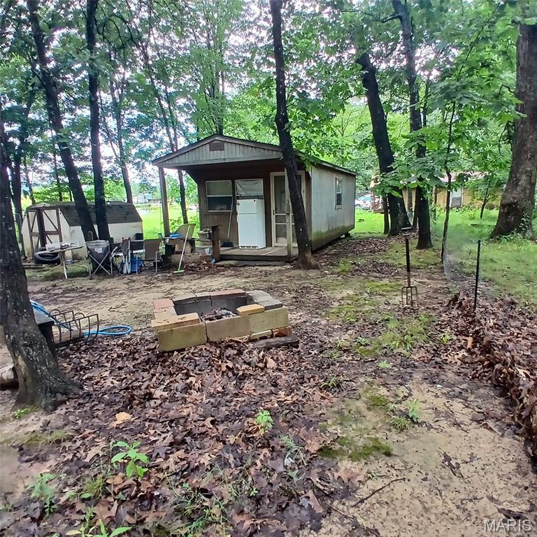 Nice 2 lots at lake hanna! Comes with a small cabin and a camper! The camper has a little building built over it, so if you decided to, you could move it out and pull in another one! Built on steel beams. This lot offers cozy camping on a peaceful road and does have a view of the water! The motor home in the driveway is in the process of being moved and does not go.