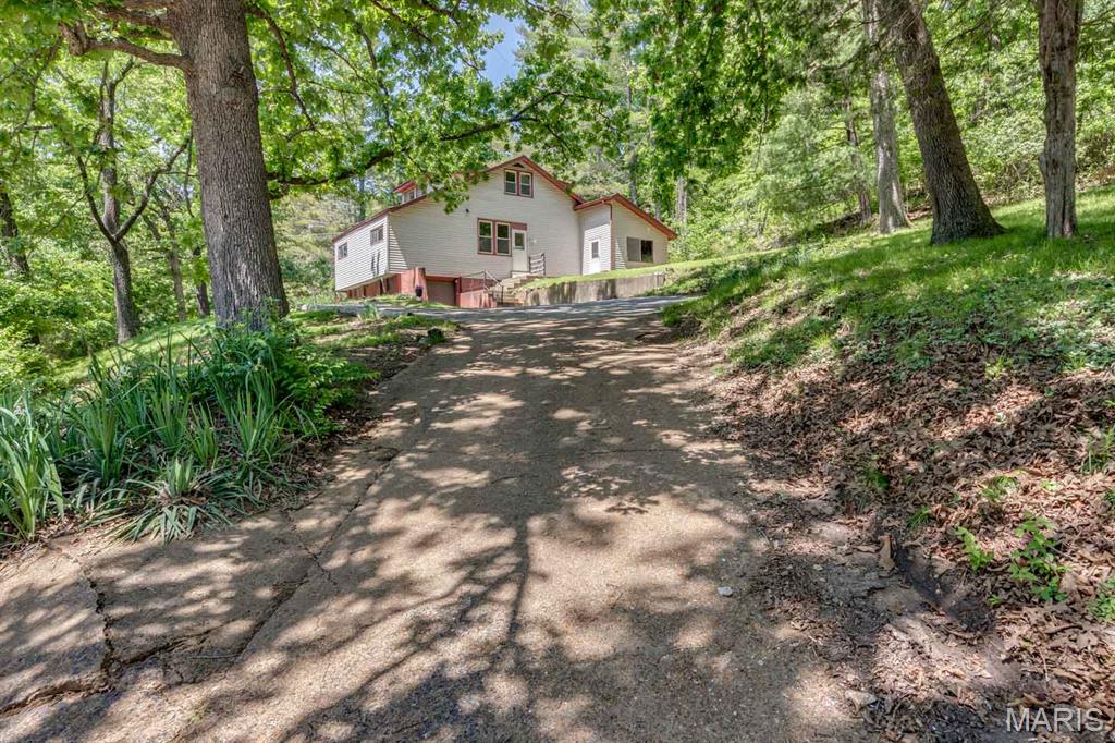 Peaceful country living on over 4 private acres with no restrictions! This 4 bed 1.5 bath home backs to woods and offers the perfect setup for hunting, horses, farm animals, gardening, or your dream homestead. Previous owner had horses.
Conveniently located just 5 minutes from local shopping, grocery stores and everyday amenities while still offering privacy and seclusion.  Bonus, a quick drive if needed to larger cities such as Fenton and St Louis. Privacy, seclusion yet still close to everything! 
Inside you will find a large kitchen, spacious living area, and a fully enclosed back porch off the kitchen as an added family room and featuring an additional wood stove- perfect for relaxing year round. The home includes multiple heat sources with electric, propane, and wood stove options for added comfort and flexibility. Additional features include a tuck under 1 car garage, well and. septic, and a newer roof approximately 6 years old.  Located in the Northwest School District.