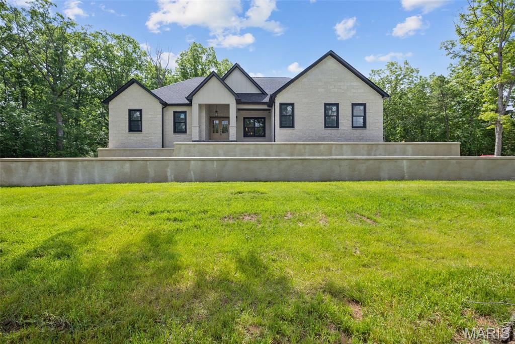 Experience the ultimate blend of country privacy and modern luxury in this stunning, brand-new custom ranch home situated on 3.66 acres just outside Potosi city limits! Boasting 2,200 sq. ft. of main-level living space, this 4-bedroom, 2-bathroom masterpiece shines with premium upgrades throughout. A striking custom limestone facade welcomes you inside to a light-filled, open-concept layout centered around a magnificent limestone fireplace. The gourmet kitchen is a chef’s dream, fully equipped with custom cabinetry, premium KitchenAid appliances, sleek quartz countertops, and a matching quartz backsplash—perfect for entertaining. Escape to the massive master suite, complete with an expansive walk-in closet and a spa-like bath featuring a custom walk-in shower. Need more space? The massive full walk-out basement is a blank canvas ready for your finishing touches, already framed and plumbed for a 3rd bathroom, and stepping out to your private acreage. Complete with an attached 2-car garage and located just a short drive from outdoor recreation at Mark Twain National Forest, Huzzah Valley Resort, and the YMCA Trout Lodge. Enjoy the freedom of county living with no city restrictions, just minutes from town!