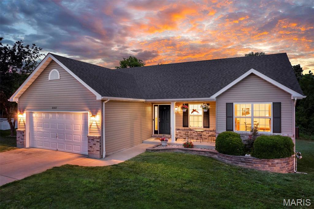 Tucked away against a backdrop of mature trees and more than 8 acres of common ground, this exceptional 4 bed, 3 full bath ranch offers privacy, space, and spectacular updates. With nearly 2,400 square feet of finished living space, an outstanding walkout lower level, and a brand-new roof, this home is truly move-in ready.  Inside, soaring vaulted ceilings, beautiful wood floors, and abundant natural light create an open and inviting atmosphere. The spacious great room flows effortlessly into the kitchen, featuring an island, pantry, updated appliances, and stylish backsplash. Just off of the kitchen is a mud room / main floor laundry room! The primary suite offers vaulted ceilings, a walk-in closet, and private full bath. Step outside to enjoy the expansive deck and updated patio overlooking a peaceful wooded setting that provides exceptional privacy and a natural backdrop rarely found in a subdivision setting. Not to mention, just beyond the wood line, there is a fishing lake along with a 2nd lake in the community!  The fully finished walkout lower level is the star of the show. Large windows across the back bring in incredible natural light, making the space feel like a true extension of the main level. Highlights include a beautiful gas fireplace with stone surround and custom mantle, kitchenette with sink, microwave, and space for a full-size refrigerator, a dedicated dog wash station, and a spacious possible 4th bedroom with its own full bath and oversized walk-in tile shower. New plush carpet on main level, oversized 2-car garage, and thoughtful updates throughout. If you've been looking for a ranch that offers room to spread out, space to entertain, and a setting that feels removed from the hustle and bustle, this one deserves a spot at the top of your list.
