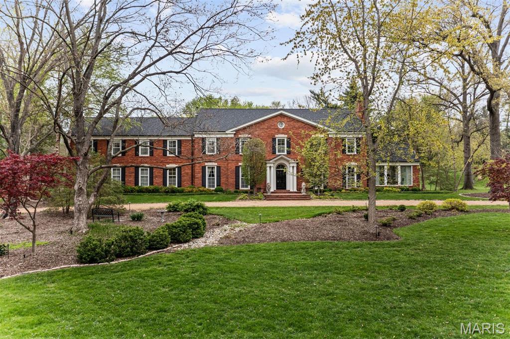 Gorgeous Georgian Colonial sits graciously on 1.8 acres on coveted Log Cabin Drive. Classic red brick & symmetrical architecture define the home's distinguished exterior. A grand two-story foyer & first floor flow, are ideal for entertaining, with generously sized living and dining rooms w/ floor-to-ceiling windows.  Modern amenities include a wet bar & first-floor mudroom/laundry w/1/2 bath.  A gourmet kitchen w/custom cabinetry, Sub Zero & Wolf appliances, opens to a handsome, wood-beamed hearth room. A sweeping staircase up to the primary suite & office, 4 addt'l bedrooms & 4 baths & bonus room. The lower level has an expansive recreation room, bar, 1/2 bath w/2 separate seating areas & ample storage. This private estate oozes luxury w/professionally installed landscape lighting, pool & pool house w/full kitchen, 2 full baths & an extra garage space ideal for a golf cart or exercise room all providing a personal sanctuary within walking distance to Ladue shops & schools.