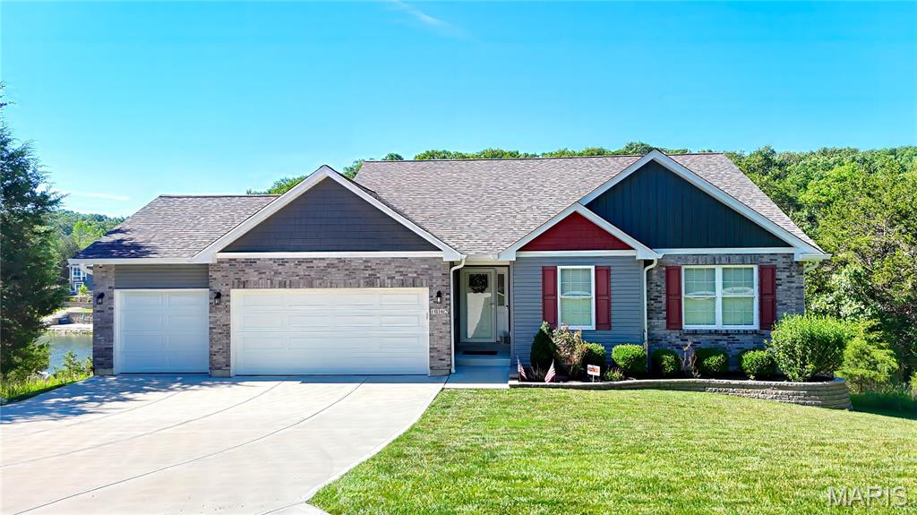 Discover the essence of lake front living at 10162 Lake Ridge DR, Hillsboro, MO 63050. This single-family residence, constructed in 2020, offers a contemporary foundation for a desired lifestyle. This inviting property offers a unique opportunity to own your own lake front home with the most beautiful view. Owner took pride when designing their dream home. Beautifully decorated to show off the style. From the moment you walk in the front door to the exit out the lower level to your private dock, you will appreciate this design. Interior is perfectly arranged. Open floor plan with access to main living areas. Check out the pictures and video to showcase your new home. Cathedral Ceiling opens the Living up to settle the masonry fireplace. Center kitchen island allows entertainment and seclusion for the chef! Beautiful granite countertops are on display. There are stainless appliances to include the Refrigerator, Electric stove, built in microwave, dishwasher, washer & dryer, which Owners have decided to leave for you to enjoy. Lighting through out the house is perfect, Owner took their time to ensure every light was perfect for the area. Dining Area has view of the lake and allows exit to the covered composite deck that also is attached to the Primary Bedroom. The hallway is inviting with a desk area and cabinet. Open area allows a place for that unique piece of furniture that you just have to have. Primary Bedroom is beautiful with access to the covered deck that leads back to the Dining Area. Primary Bedroom has a bathroom suite with a double bowl sink, walk-in shower with seat, linen closet and a walk in closet. Bedroom 2 and 3 are located nicely in the front of the home and beautifully decorated, their windows give a ray of sunshine. There is a chair left that is installed on the staircase to the lower level that will be staying in the home. The lower level is partially finished with a greeting Family Room, 4th bedroom, full bathroom, Kitchenette. Sitting in the lower level Family Room gives a beautiful view of the lake and access to the covered patio area, sidewalk to your private dock, and nice fenced in backyard for your fur family members. The 4th bedroom has windows for that panoramic view of your lake front property. The other side of the lower level has plenty of room for many uses. Use this area as a work out room, pool table, and it could be used as a 5th bedroom because it does have a window or guest room if desired. This part of the lower level has access to the outside as well. It allows exit to the side yard. There's a nice storage area as well to keep your precious items stored. The sidewalk to the dock is landscaped, handrail all the way to the dock, and lighted.  You will want to own this home!