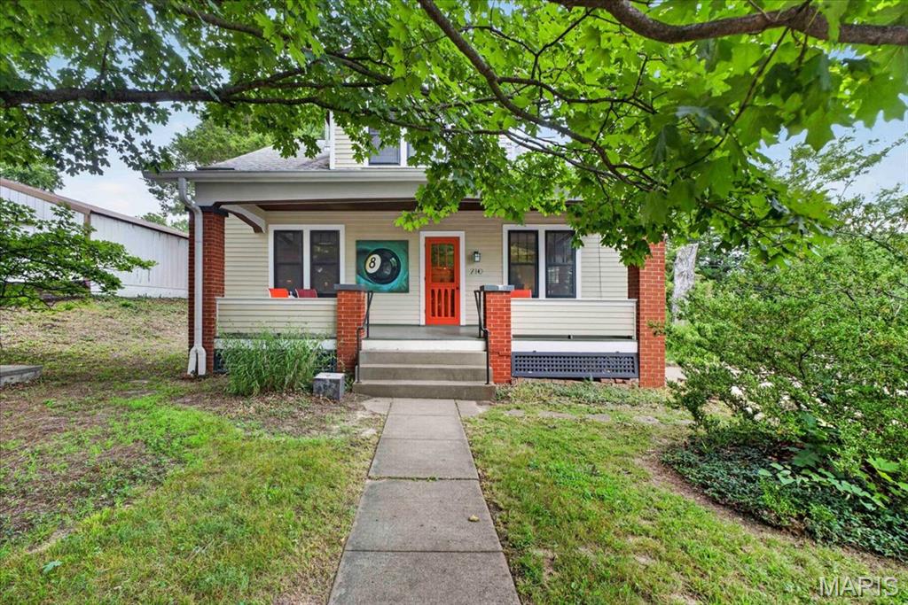 Step into a piece of Augusta history with this beautifully preserved and thoughtfully maintained 1937 home, where timeless charm meets everyday comfort. Situated on nearly an acre in the heart of Missouri Wine Country, this 5-bedroom, 2-bath residence offers over 2,000 square feet of inviting living space filled with original character, warm wood flooring, and abundant natural light. From the moment you arrive, the welcoming covered front porch sets the tone for the home's classic appeal. Inside, spacious living and dining rooms provide the perfect backdrop for entertaining, while the bright kitchen offers generous cabinetry, ample workspace, and a functional layout that blends vintage charm with modern convenience. The flexible floor plan features two bedrooms on the main level and two additional bedrooms upstairs, creating plenty of space for family, guests, or a home office. An expansive upper-level bonus room offers endless possibilities as a media room, playroom, studio, or additional living space. The unfinished basement provides abundant storage and workshop space, while the tuck-under area offers the opportunity to create a garage by simply adding the mechanics. Outside, the nearly one-acre level lot provides room to garden, a chicken coop, entertaining space, and peaceful surroundings beneath mature shade trees. Located just moments from Augusta's award-winning wineries, local restaurants, boutique shopping, scenic bike trails, and the Katy Trail, this home offers the perfect blend of small-town charm and country living while remaining conveniently accessible to St. Charles and St. Louis County. Whether you're looking for a full-time residence, weekend retreat, or investment opportunity in one of Missouri's most desirable destinations, this property is truly one of a kind.