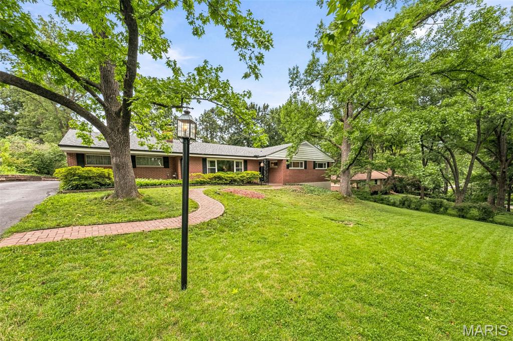 Mid century modern 4 bedroom 2.5 bathroom home sits on a .45 acre lot offering a fantastic location plus privacy in the Ladue school district. Home is filled with natural light from oversized updated windows in almost every room. Family room has a fireplace with built-in bookcases and opens to the full sized dining room. Adjacent to the dining space is the large kitchen and breakfast room. Kitchen has tons of counter space and ample cabinets. Kitchen windows provide a fantastic view of the backyard. Primary suite has a walk-in closet and attached bathroom. 2 additional bedrooms and full bath complete the main level. Walk-out lower level recreation room provides extra space to spread out, have a game room, or exercise area. 4th bedroom in the lower level is perfect for guest, teens, or a home office. No worries on storage as there is a huge unfinished area with shelving and laundry area with a washer & dryer. Backyard is nicely situated providing a lot of privacy with space to garden, play, or just enjoy the view from the deck. Oversized rear entry 2 car garage with parking pad and long driveway gives guests or family plenty of space for parking. Home is close to new Olia development for future entertainment and shopping options,  the up and coming 39 North biosciences development, MICDS, CBC, Plaza Frontenac, Jewish Community Center, & Highway 40. Clayton, Lambert Airport, Creve Coeur, Olivette and University City shopping districts and restaurant districts are a quick drive from the home. Home is approved for 1 pet.