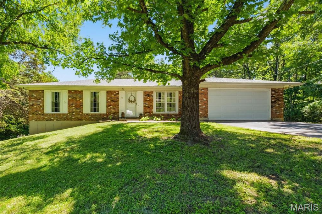 Welcome to 32 Country Lane! You will feel like you are out in the country, but only minutes from shopping and restaurants.  This adorable ranch home has everything you would want and more. Tons of large windows that give natural light throughout. Eat-in kitchen that has new appliances and original cabinets. Amazing deck off the kitchen for summer grilling or having coffee on a crisp fall day. This home features a den with a gorgeous wood burning fireplace and custom bookshelves and cabinets, perfect place to entertain your guest or just enjoy a good book in front of the fire. There is a primary suit with full bathroom and 2 additional bedrooms. The finished basement is equipped with a dry bar, tons of space and storage and walks out to a fenced yard. There is a shed and outbuilding perfect for a workshop. You don't want to miss your chance on this charming home.  Inquire today to schedule your private viewing.