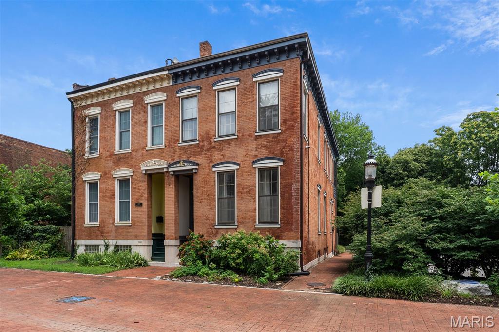 An incredibly curated pad with a creative art house vibe awaits on this pedestrian promenade in hidden La Salle Park. A designer's eye & aesthetic sets the tone to the unexpected layout & serene setting, yet architectural elements remain with a sweeping original stairwell, historic hardwoods & carved exterior facia & exposed brick accents throughout.  The vast main levels double as entertainment, dining & living areas with an amazing built-in bar & 2 decorative fireplaces. Even the kitchen is high design w/ angled open shelving & a built-in breakfast bench in the bay window with a bonus room that leads to the quaint courtyard. A mix of eclectic & industrial elements are a "creative's" dream come true with workshop, sewing studio and endless wallspace in the gallery like levels above to display your one-of-a-kind works. Movin' on up the second level is a respite for relaxing with a primary suite that faces the pedestrian mall & a well appointed spa-like primary bath.  A second bedroom has it own full bath for sharing space & a lounge for relaxing lies in between with an exposed beam ceiling. Look up & follow the soaring stairs to the loft above with a bedroom sleeping area &chill spot to perch in or on the outdoor veranda. The sweet location & historic neighborhood complete the package. You'll be situated on a quaint cul-de-sac with offstreet parking, access to events and area attractions in a residential neighborhood with strong community & deep roots.