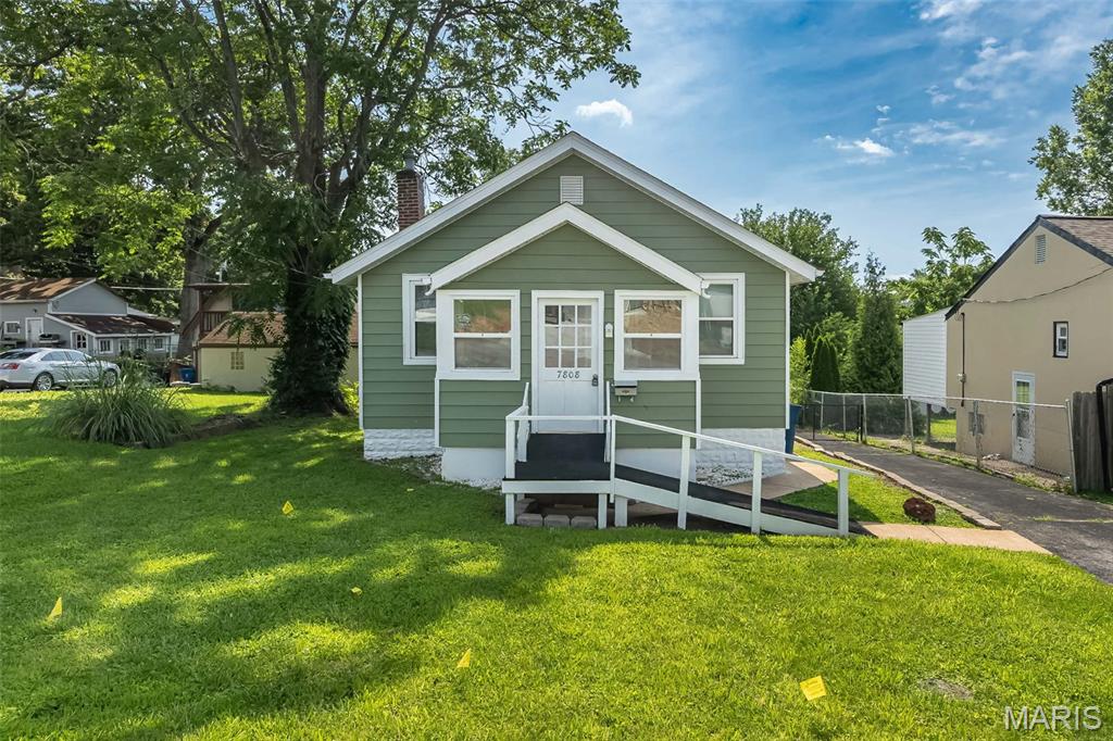 Updated charmer with move-in-ready appeal and great starter-home value! This light-filled home is ready for immediate occupancy and offers the comfort, updates, and flexibility today’s buyers want. A bright enclosed sitting porch creates the perfect spot for morning coffee, a reading nook, or a welcoming entry. Inside, the spacious living room features crown molding, a ceiling fan, and neutral decor that makes the home feel warm and inviting.
The renovated eat-in kitchen offers plenty of cabinetry, granite countertops, and newer stainless steel appliances, making it both stylish and functional. Two generously sized bedrooms feature ceiling fans, crown molding, and large closets. The updated full bath includes tile flooring and a tiled tub surround. A bonus sunroom off the kitchen provides valuable flex space—ideal for a home office, mudroom, pantry/storage area, or possible main-floor laundry conversion. The walkout lower level adds even more usable space with a large private storage area, laundry area with washer and dryer included, workshop space, and an open area with endless possibilities for hobbies, fitness, storage, or future finish. Outside, enjoy a level partially fenced backyard, a deck for outdoor grilling or bistro dining, an oversized one-car garage, and an adjacent parking pad for extra off-street parking. Additional updates include newer flooring, updated paneled doors, neutral finishes, and select window treatments. Existing furniture is negotiable, making this an easy, turnkey opportunity. A must-see for first-time buyers, downsizers, or anyone looking for an affordable move-in-ready home!
