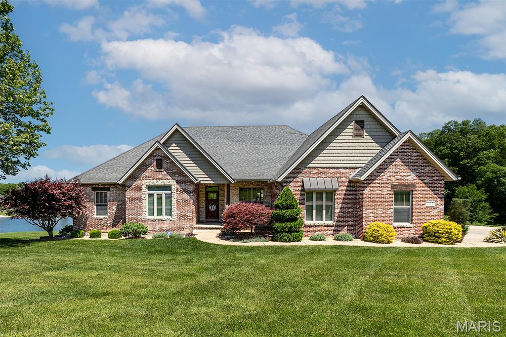 Located in Willowbrook Subdivision, this stunning 5-bedroom, 3 full/2 half bath home offers the perfect blend of comfort, style and breathtaking views. Situated on a picturesque neighborhood pond, the home was designed to capture natural light and showcase the water views through the expansive windows. The heart of the home opens seamlessly to an incredible screened-in porch area to enjoy the views, while the lower level takes you to a wonderful escape in the attached pool house and inviting pool. These spaces create the ultimate indoor-outdoor entertaining experience. Automatic screens and clear garage-style doors on the pool house allow you to enjoy the beauty of every season — open them up to enjoy the beautiful pool and fresh air on warm evenings or keep cozy by the gas fireplace while still taking in the stunning views on chilly days. Inside, you’ll find inviting gathering spaces, both on the main and lower levels, and a layout ideal for both everyday living and entertaining. The large kitchen provides ample space for the chef in the house, and to host your friends and family. A 3-car garage provides ample storage, while city utilities paired with county living offer the best of both worlds. This exceptional property combines luxury, functionality and peaceful waterfront living in one unforgettable home.