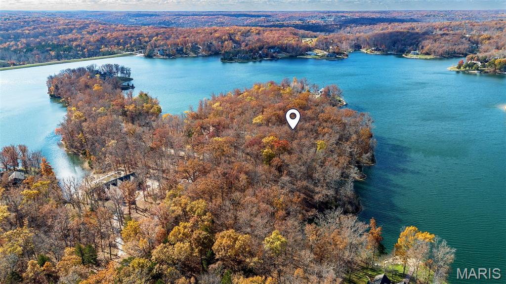 A truly exceptional opportunity—this rare double lakefront lot on Innsbrook’s premier Lake Alpine spans more than 2.38 acres with over 650 feet of shoreline, offering a one-of-a-kind setting for your custom dream home. Widely regarded as one of the most spectacular properties ever available on this coveted lake, the homesite captures panoramic water views and an unparalleled sense of privacy amid the natural beauty of Innsbrook. The land’s gentle topography and mature hardwood canopy provide a stunning backdrop for a legacy lake residence with endless design possibilities—whether you envision a sprawling vacation retreat or your forever home nestled among the trees. With multiple vantage points for decks, patios, and outdoor entertaining, every angle can be oriented to showcase sweeping views across the widest section of Lake Alpine. Nestled within an enclave of distinguished lake homes on a quiet road, this property represents the ultimate blend of prestige and serenity. Enjoy direct access for swimming, boating, fishing or simply soaking in the peaceful rhythm of the water. A rare chance to own one of the most desirable parcels in the entire resort community—where breathtaking scenery meets extraordinary potential. Buy now, build when you are ready. Enjoy all of Innsbrook's amenities while you wait for your dream home to be built.