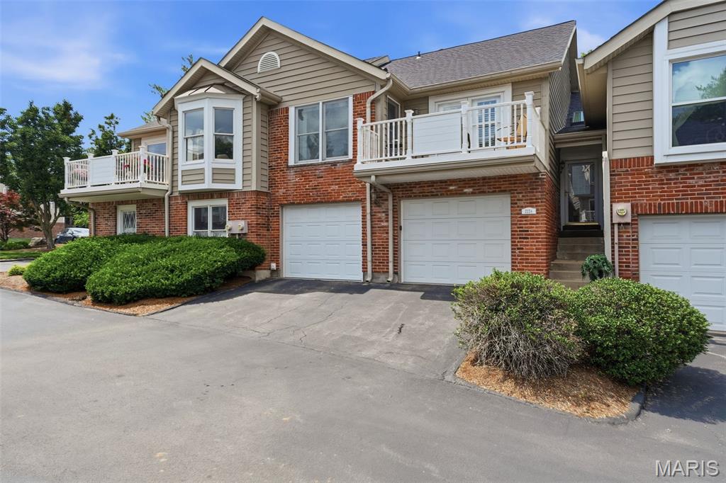 Looking for a beautiful, move-in ready townhome in a highly desirable area? Located just a short walk from the Town and Country Crossing which offers lots of fun shopping and great restaurants, this townhome fits all these criteria perfectly and is located near Top Rated Schools and Hospitals. Highlights include brand new tasteful flooring, beautiful new carpet and fresh neutral paint plus the wonderful kitchen area and updated bathrooms.
This updated kitchen has granite counter tops, professionally painted cabinets with soft close drawers and new stainless appliances including a gas stove, oven, microwave and refrigerator. It also has a breakfast bar with a granite counter and is open to the dining area. The generous dining area is open to the living room area which is bright and welcoming plus it has access to the large newer outside composite deck that is great for BBQing, outside dining and enjoying the sun!  There are 2 huge and oversized bedrooms with the primary bedroom having a sitting area and a full bath with separate shower and expansive walk in closet. The second bedroom has a juliet balcony open to the beautiful shaded courtyard perfect for bird watching and relaxing. This townhome has 2 full updated bathrooms on the main level and a half bath in the lower level. Speaking of the lower level, it is wonderful for entertaining with a large living area, pretty gas brick fireplace, lots of windows, a wet bar, built-in shelves with a secret storage area behind the swinging shelves, laundry room and an office area.
The garage is something a car aficionado would be proud of as it is completely finished plus the walls and floor are professionally painted and it is oversized for your bikes etc.  The location is awesome and so convenient for easy, modern living!